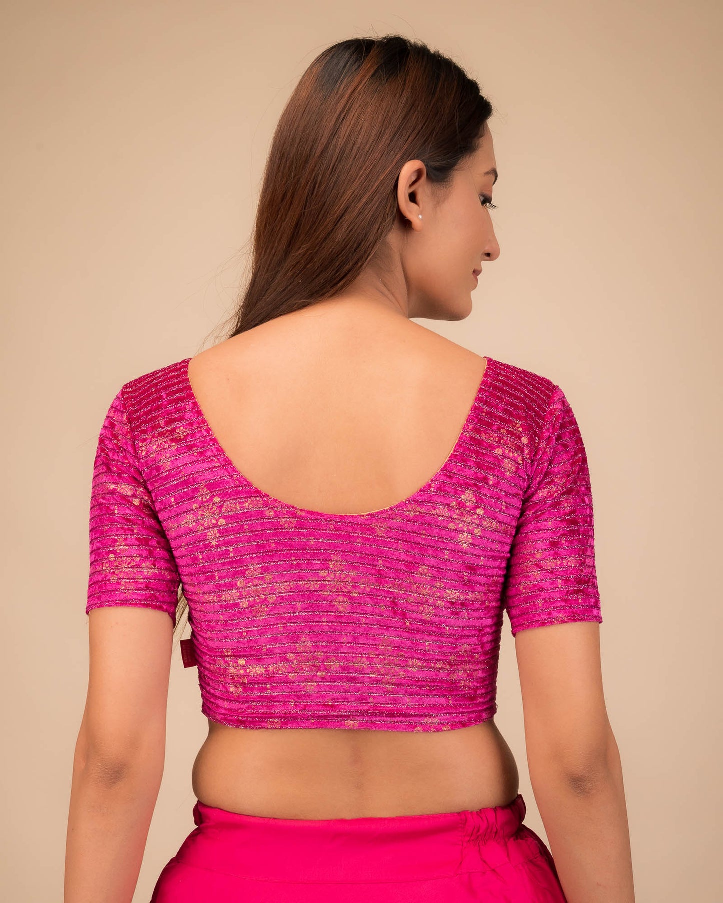 Rear view of the stretchable velvet blouse showcasing the back design.