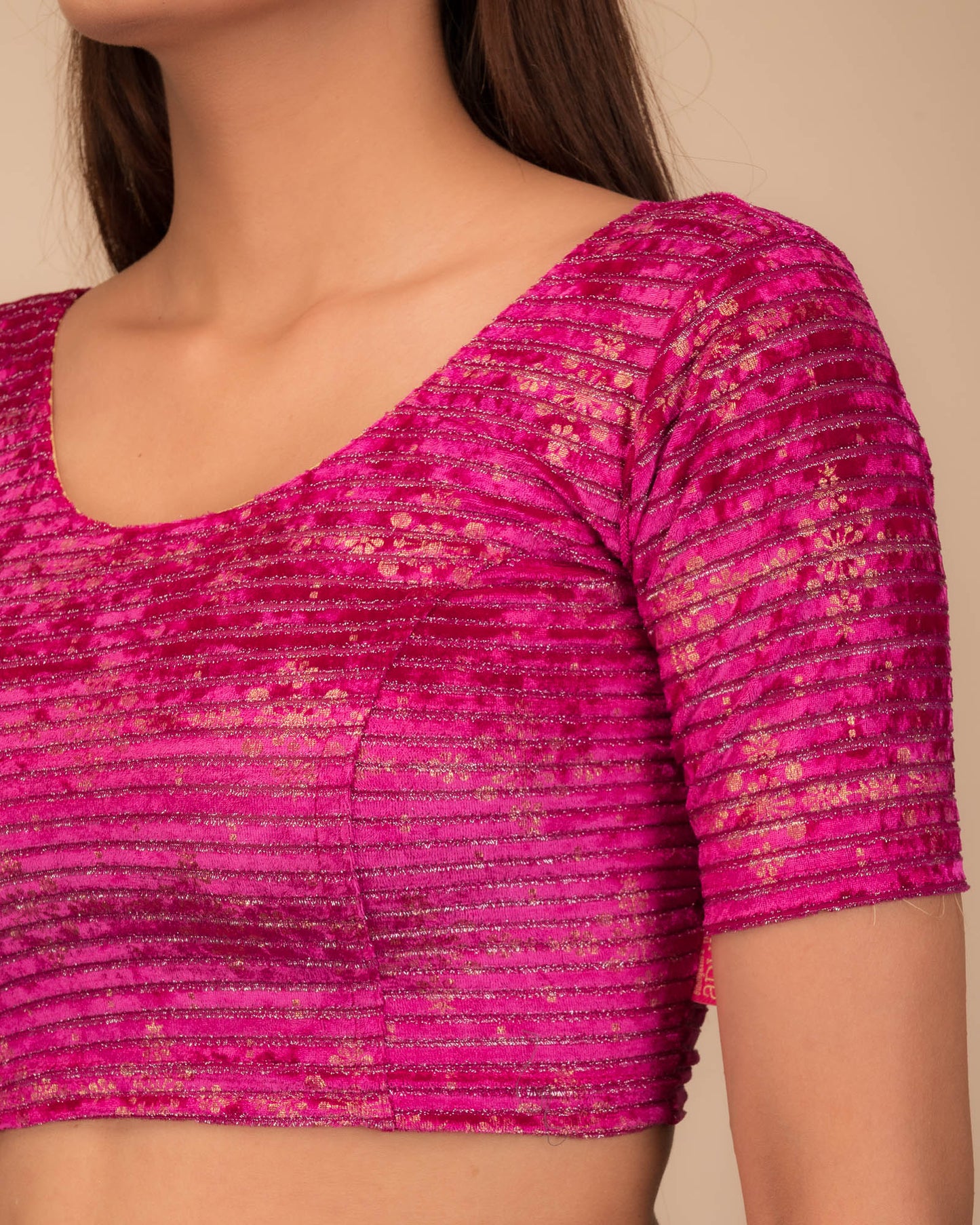 Close-up of velvet fabric with metallic foil embellishment.