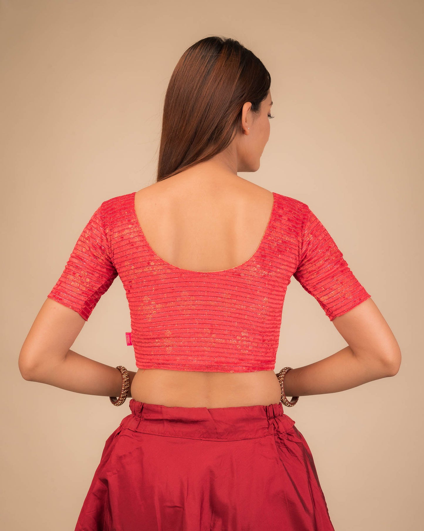 Rear view of the stretchable velvet blouse showcasing the back design.