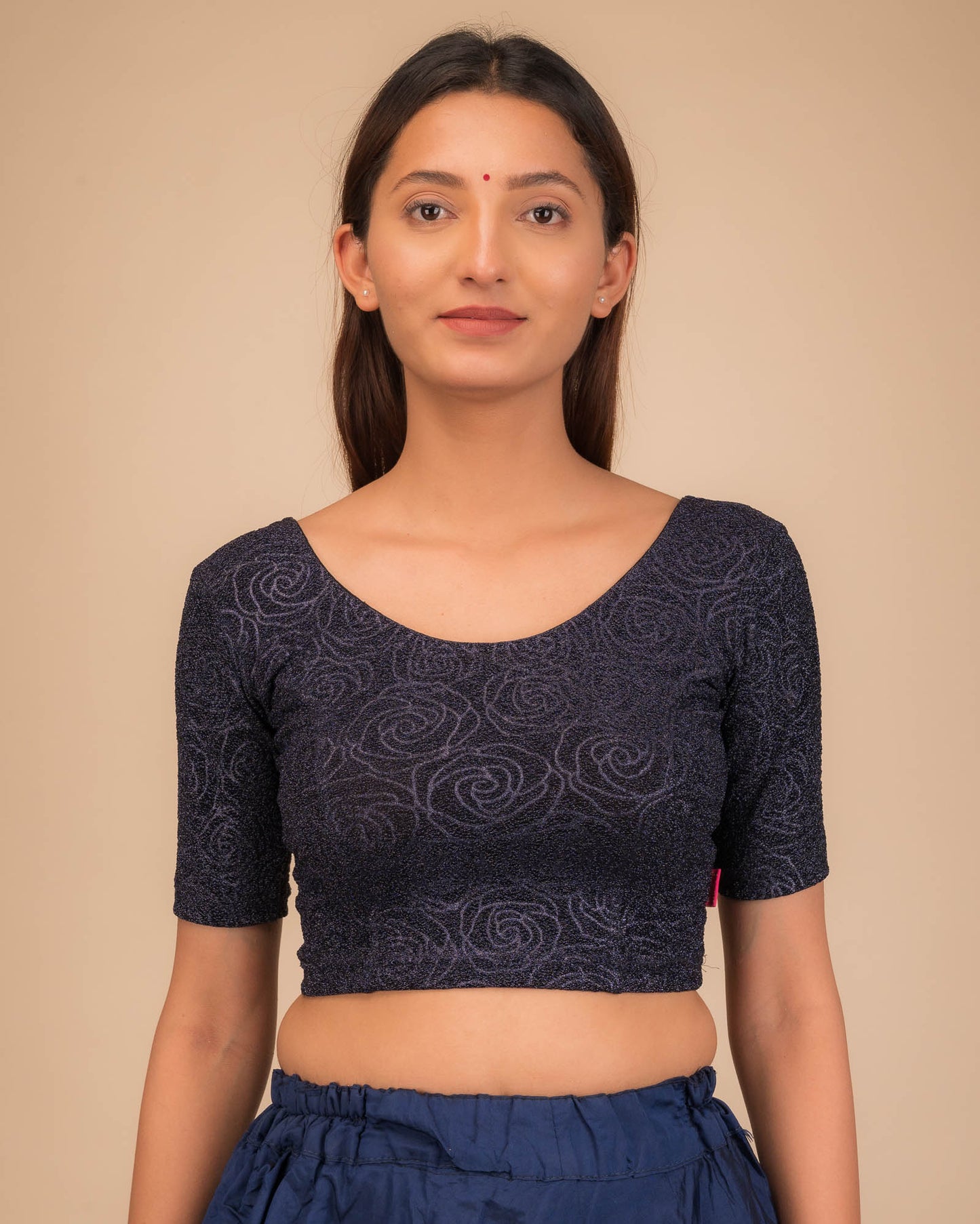 Model wearing a stretchable blouse with elbow sleeves and round