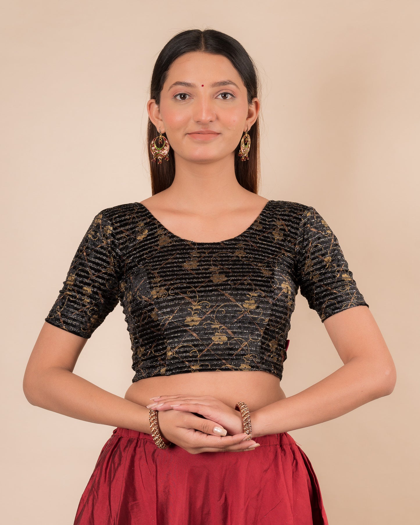 Model wearing a velvet stretchable blouse with elbow sleeves and round neckline.