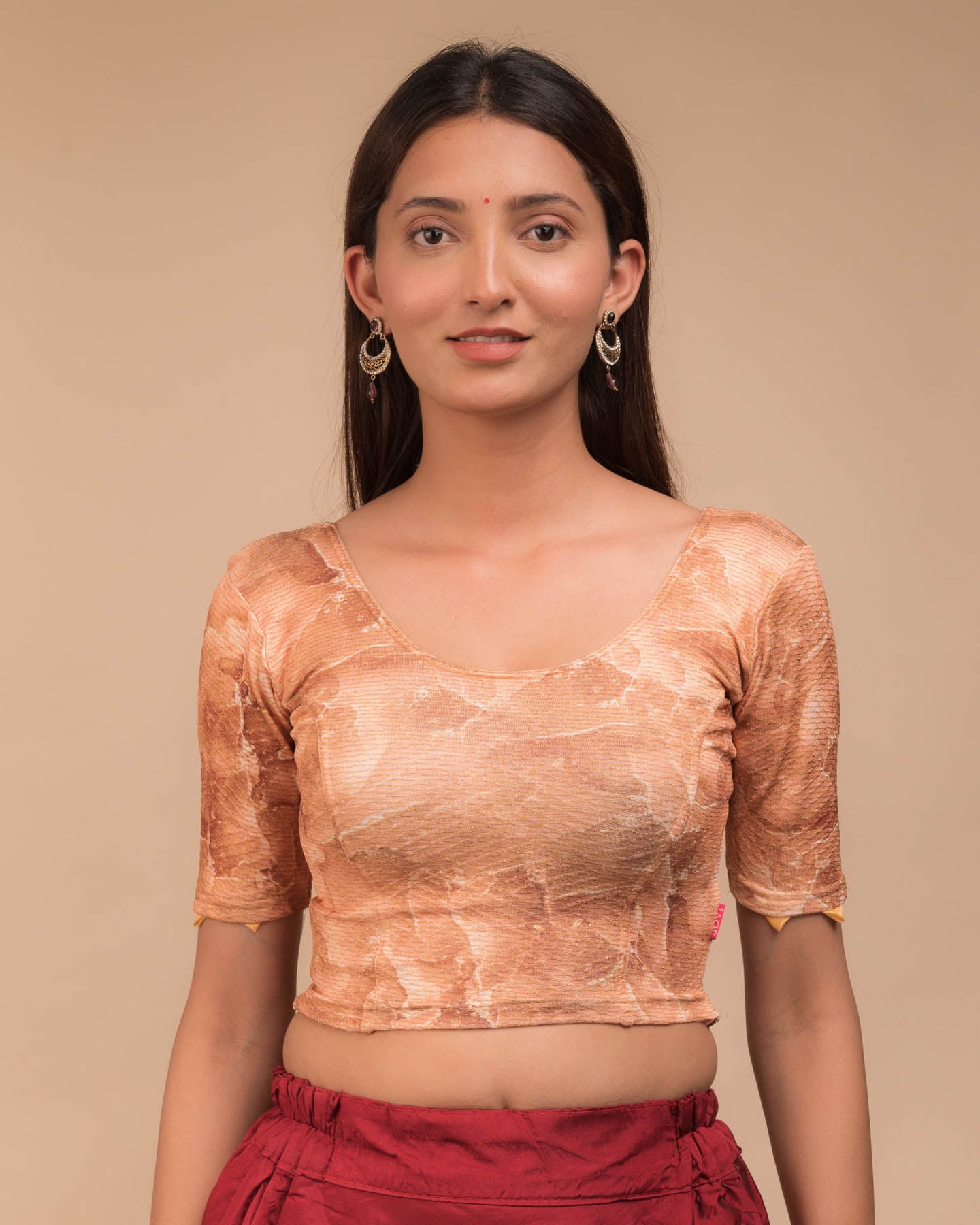 Model wearing a stretchable readymade blouse with elbow sleeves and round neckline, showcasing marbling print.