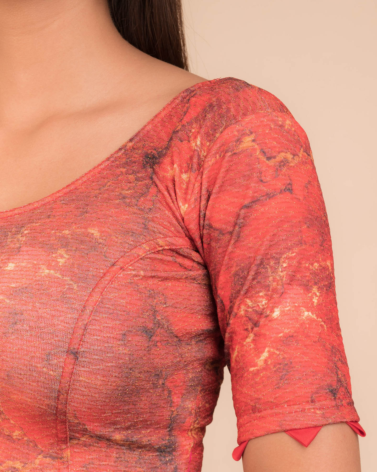 Close-up of jacquard fabric detailing the print and trims.