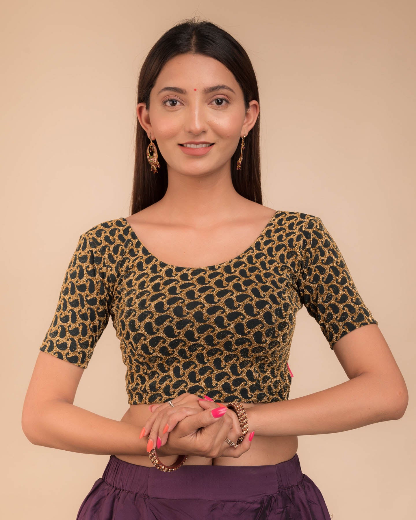 Model wearing a stretchable blouse with elbow sleeves and round neckline, featuring zari detailing.