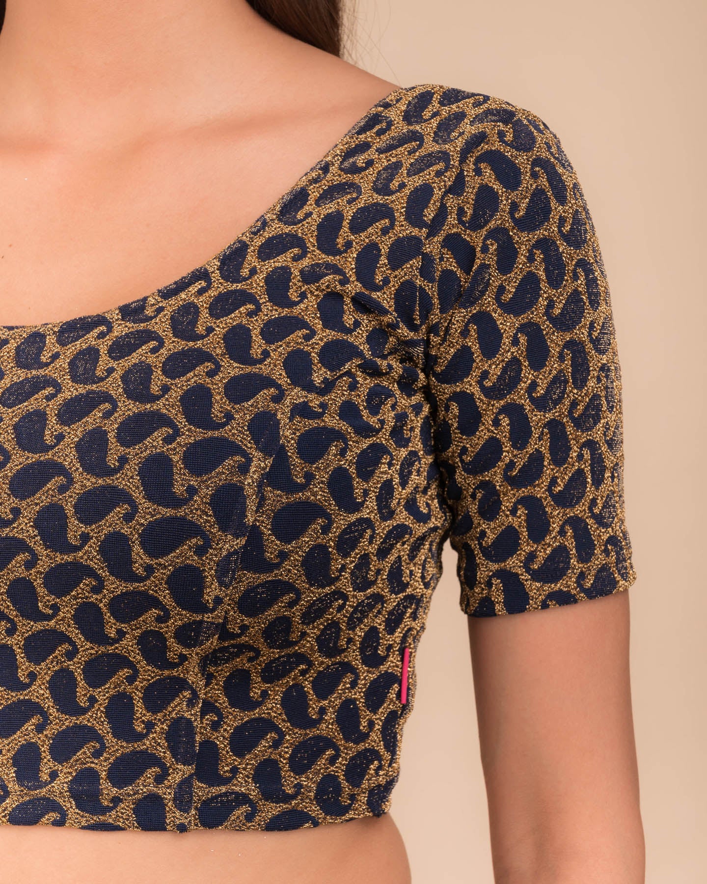 Close-up of jacquard fabric with zari pattern.