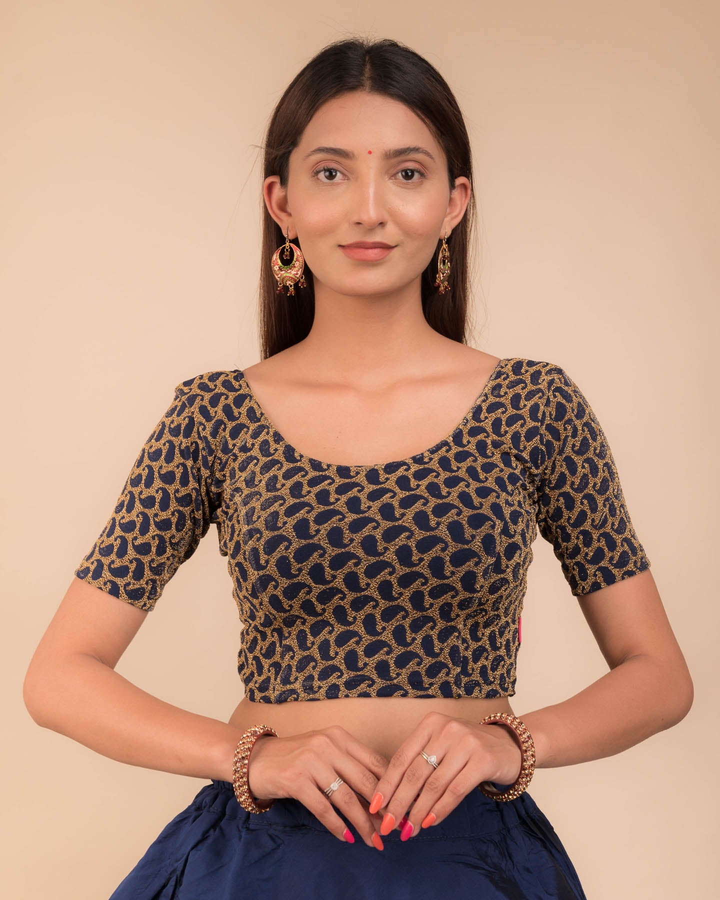 Model wearing a stretchable blouse with elbow sleeves and round neckline, featuring zari detailing.