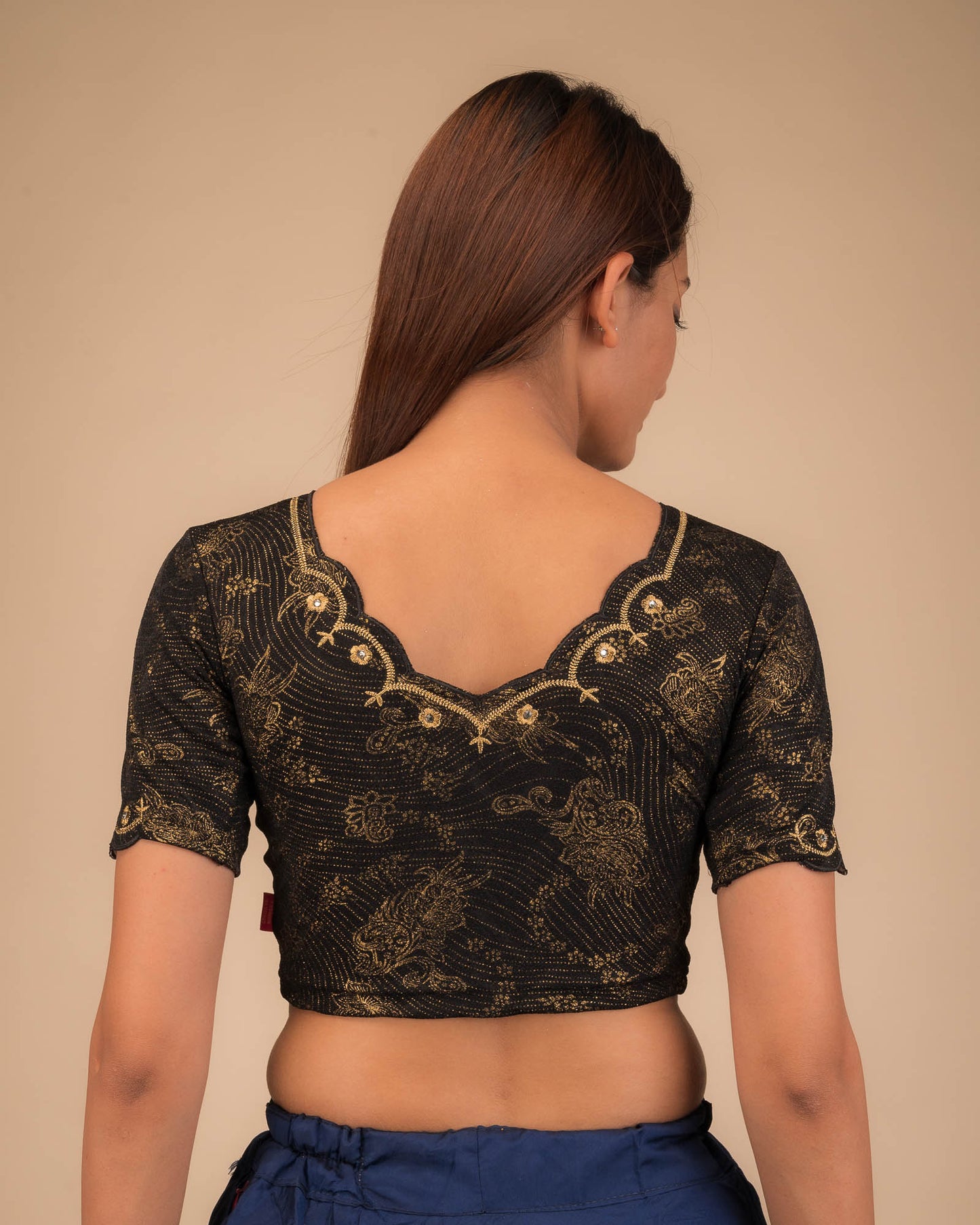 Rear view showing the back design and scallop-edge sleeves.