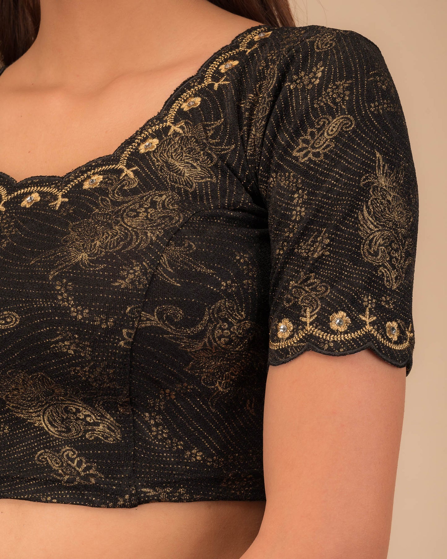 Close-up of jacquard knit with detailed embroidery.