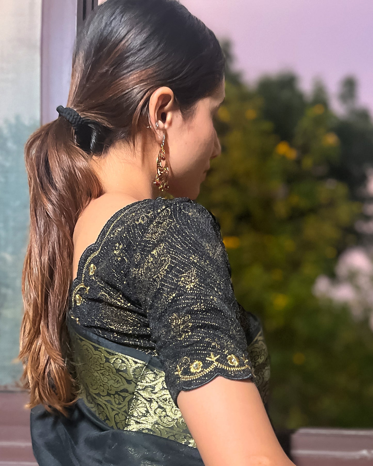 Model pairing the blouse with a saree for a festive-ready look.