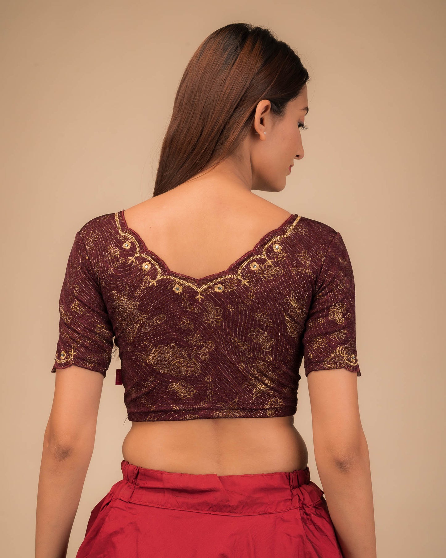 Rear view showing the back design and scallop-edge sleeves.