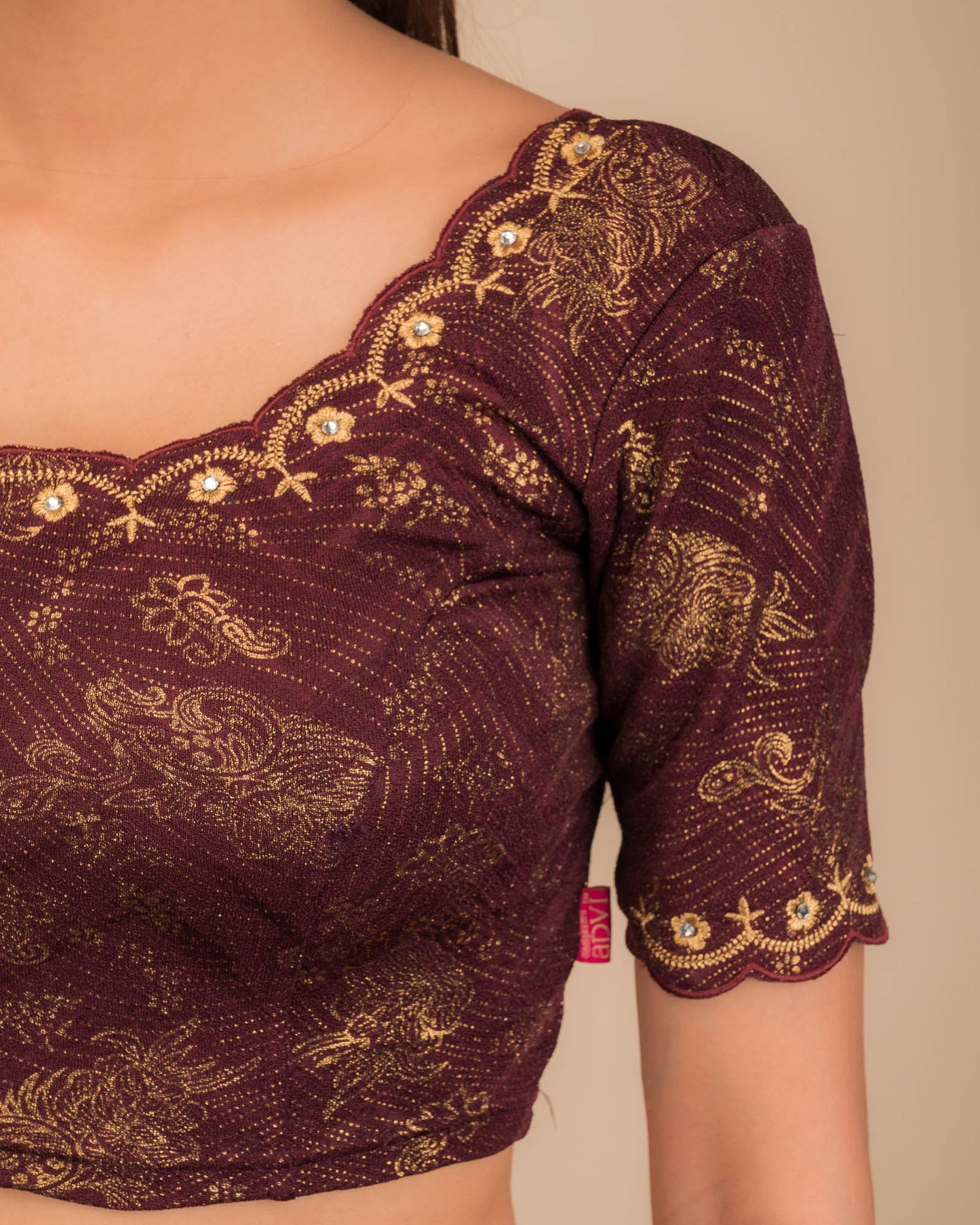Close-up of jacquard knit with detailed embroidery.
