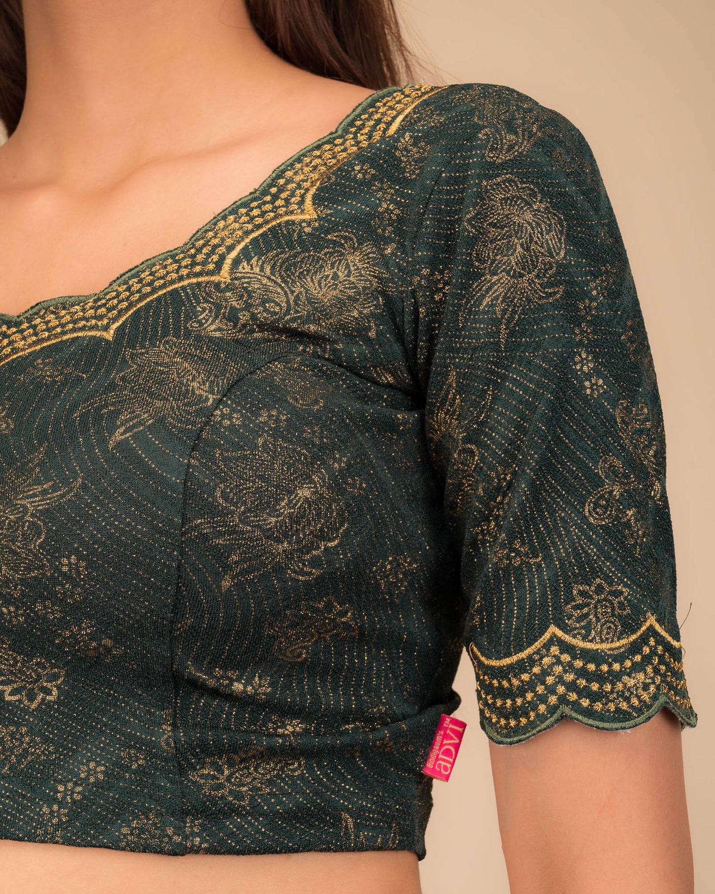 Close-up of jacquard fabric detailing the intricate embroidery and stones.