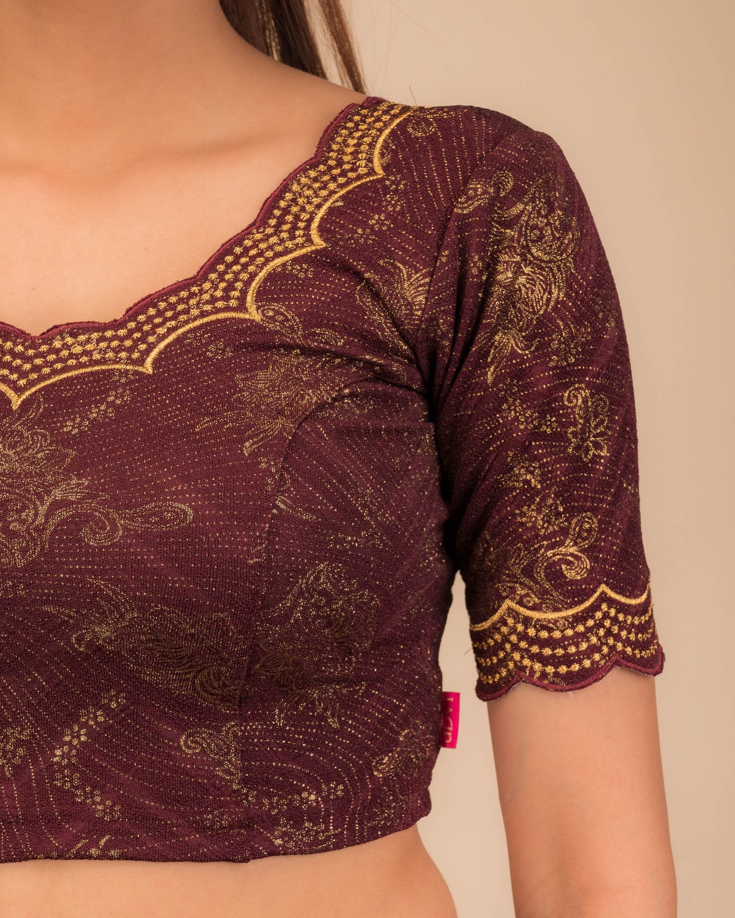 Close-up of jacquard fabric detailing the intricate embroidery and stones.
