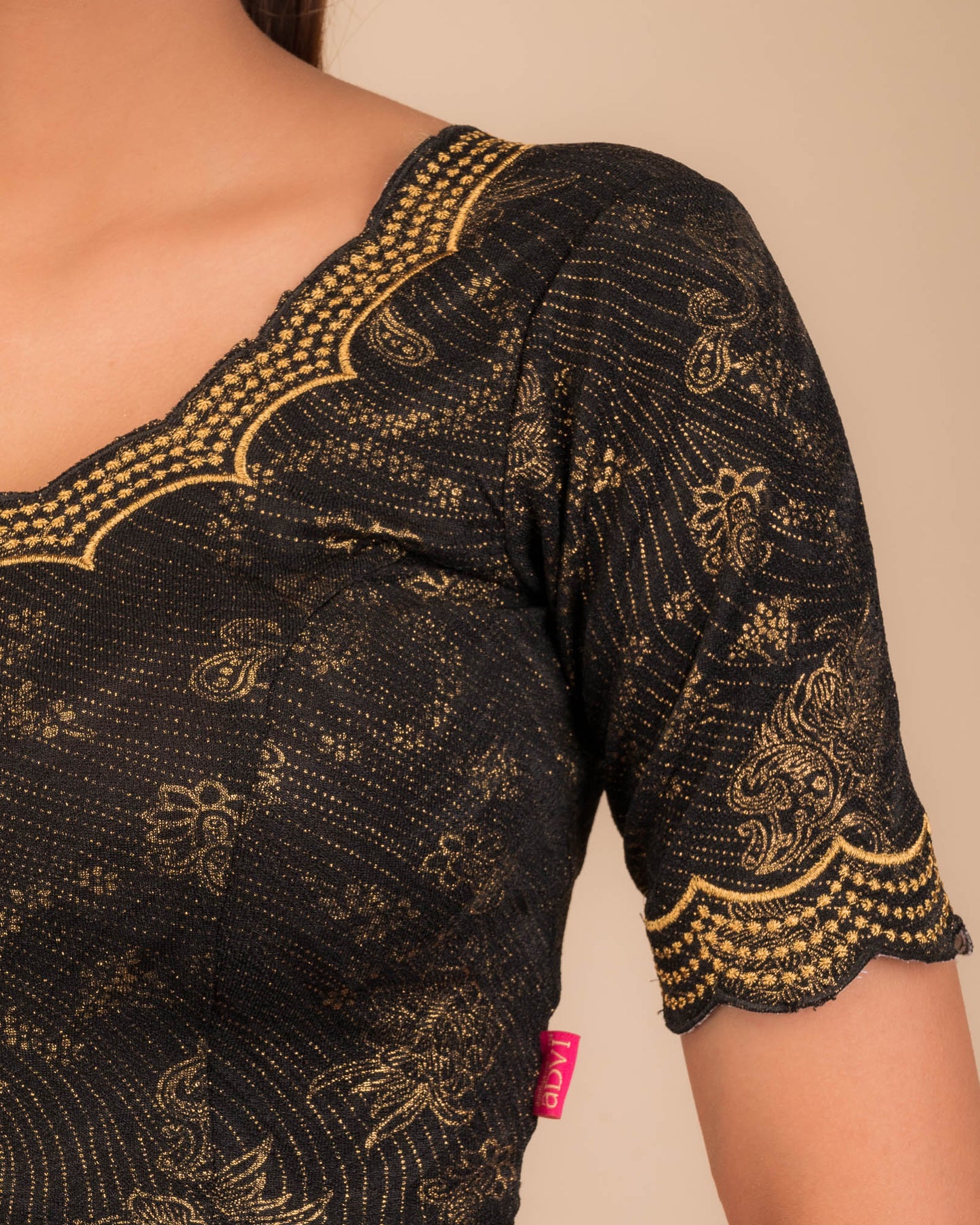 Close-up of jacquard fabric detailing the intricate embroidery and stones.