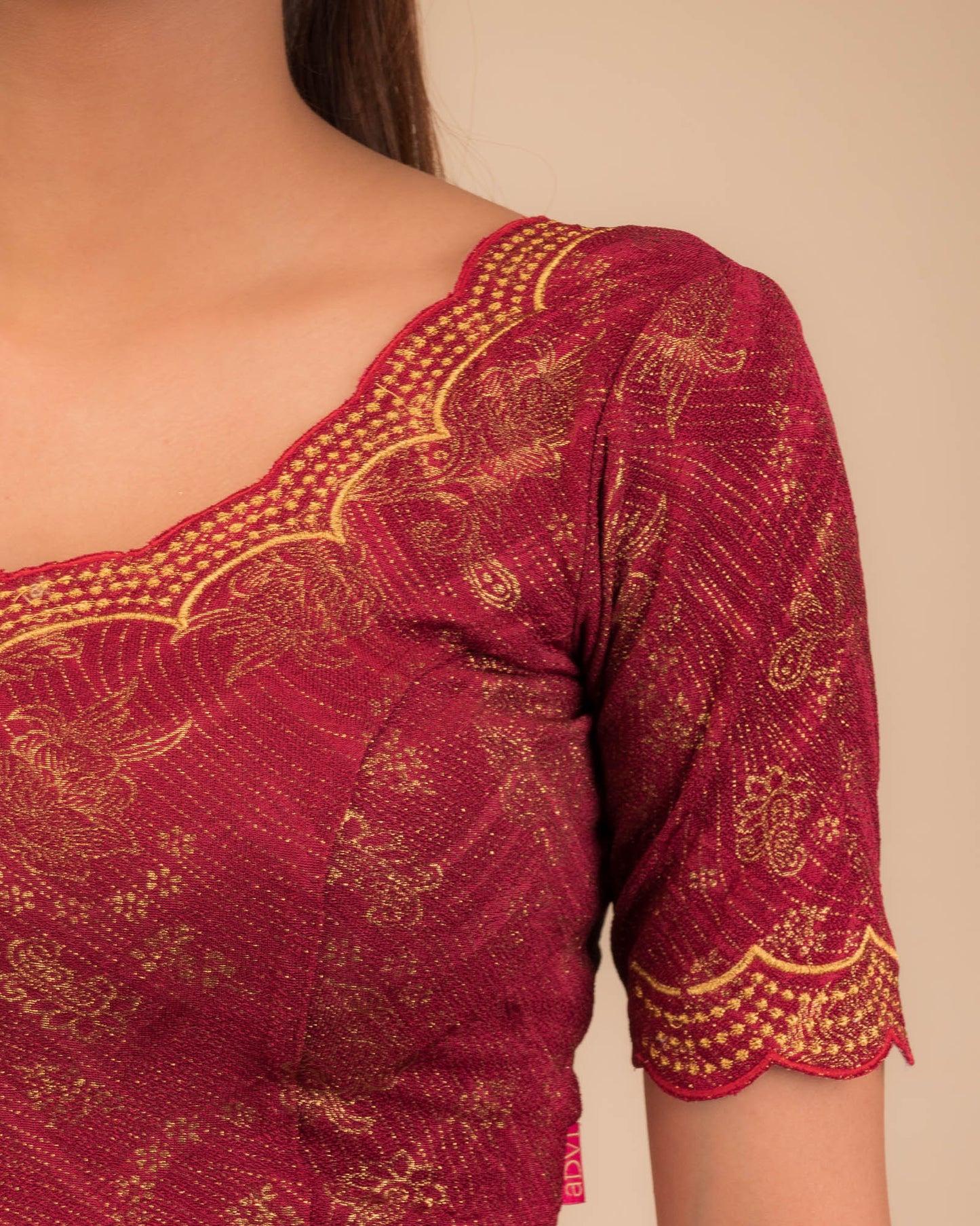 Close-up of jacquard fabric detailing the intricate embroidery and stones.