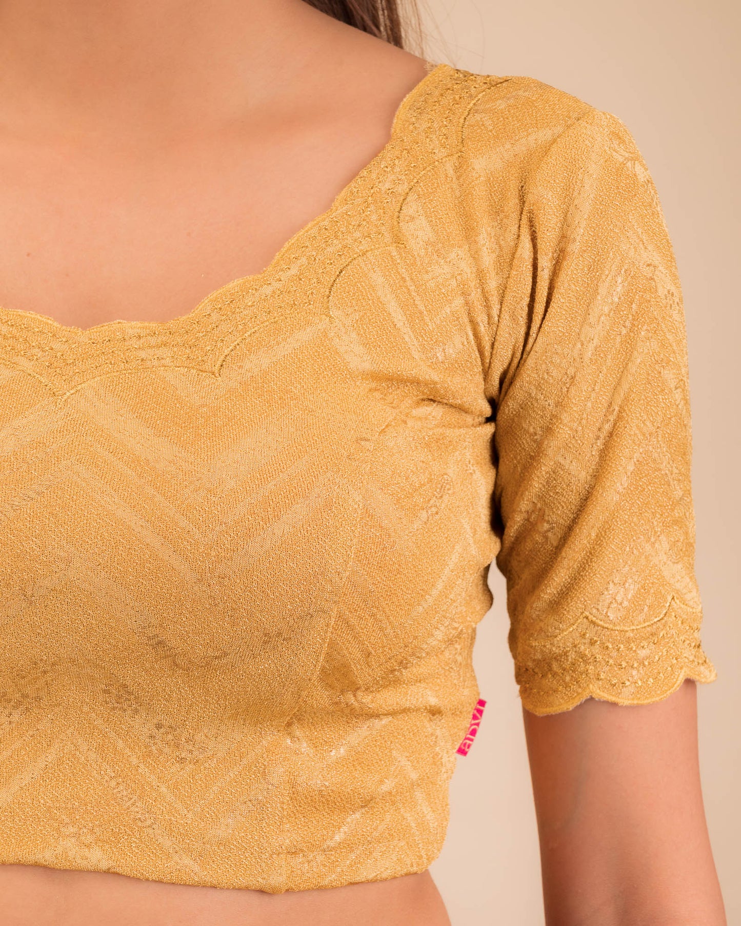 Close-up of jacquard fabric detailing the intricate embroidery and stones.