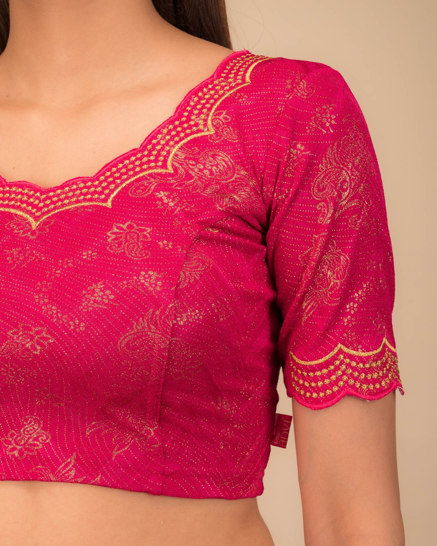 Close-up of jacquard fabric detailing the intricate embroidery and stones.