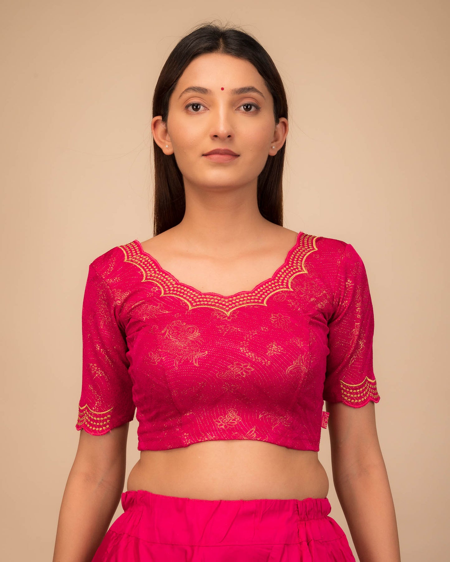 Model wearing a stretchable blouse with elbow sleeves and round neckline, featuring floral embroidery with stone accents.