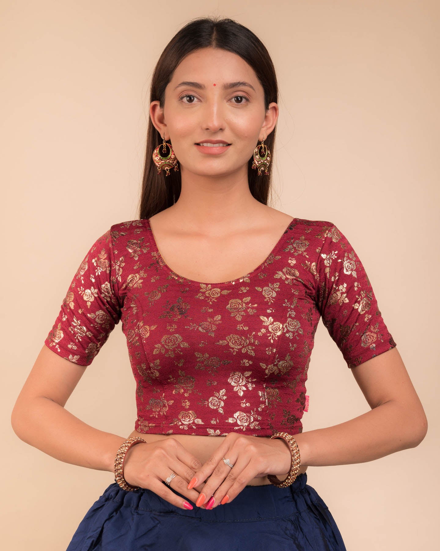 Model wearing a stretchable blouse with elbow sleeves and round neckline, featuring metallic foil floral print.