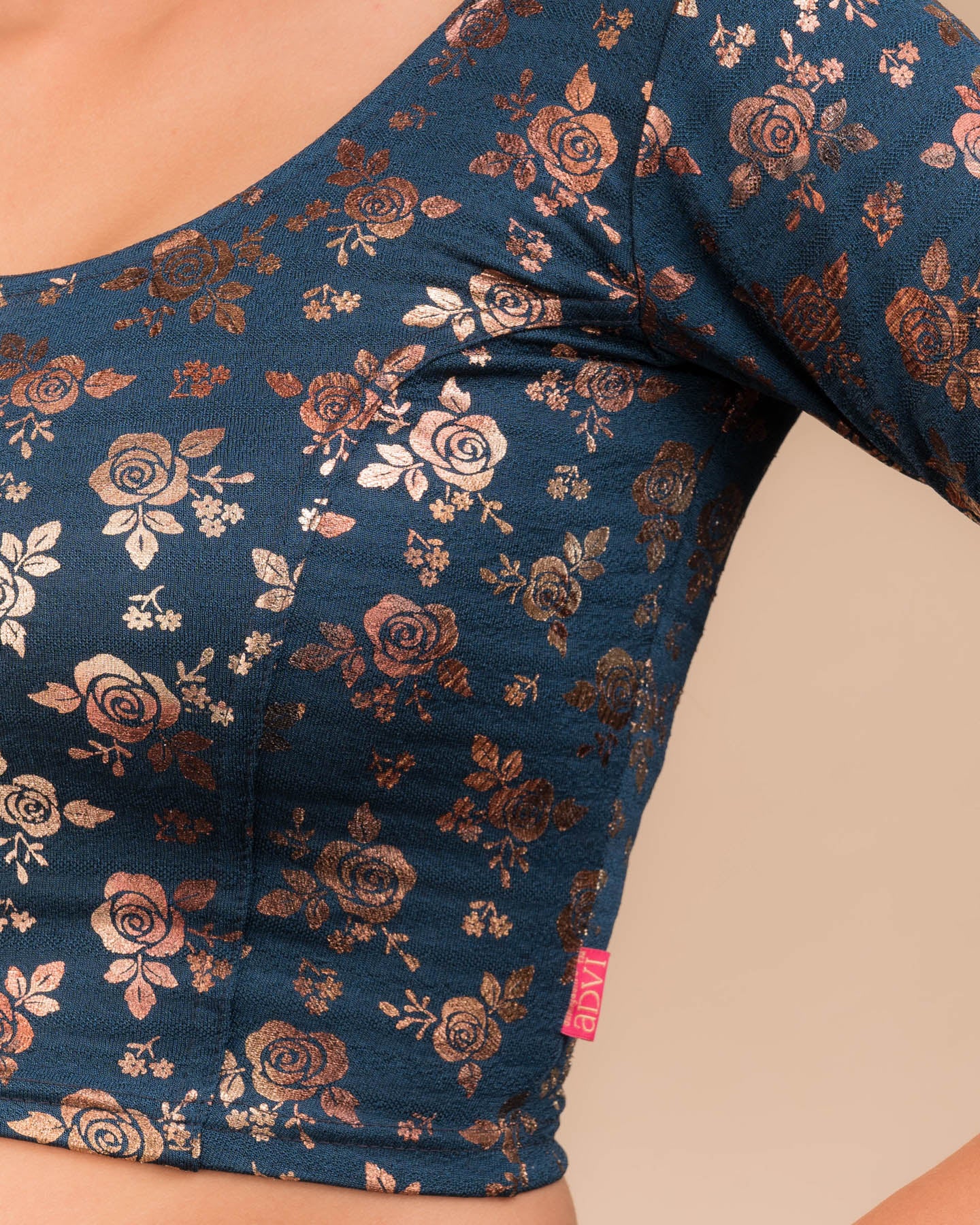 Close-up of the textured fabric with foil floral detailing.