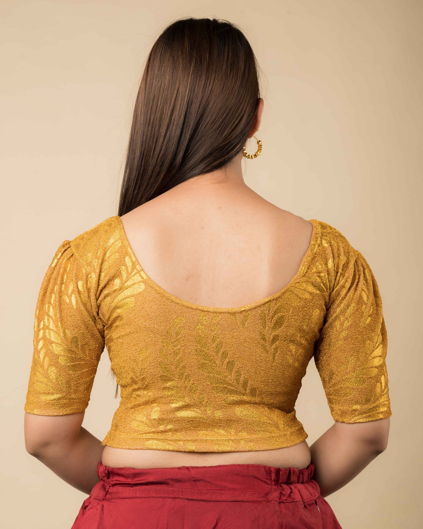 Rear view of metallic zari blouse with rose print showing fit and rose pattern detailing.