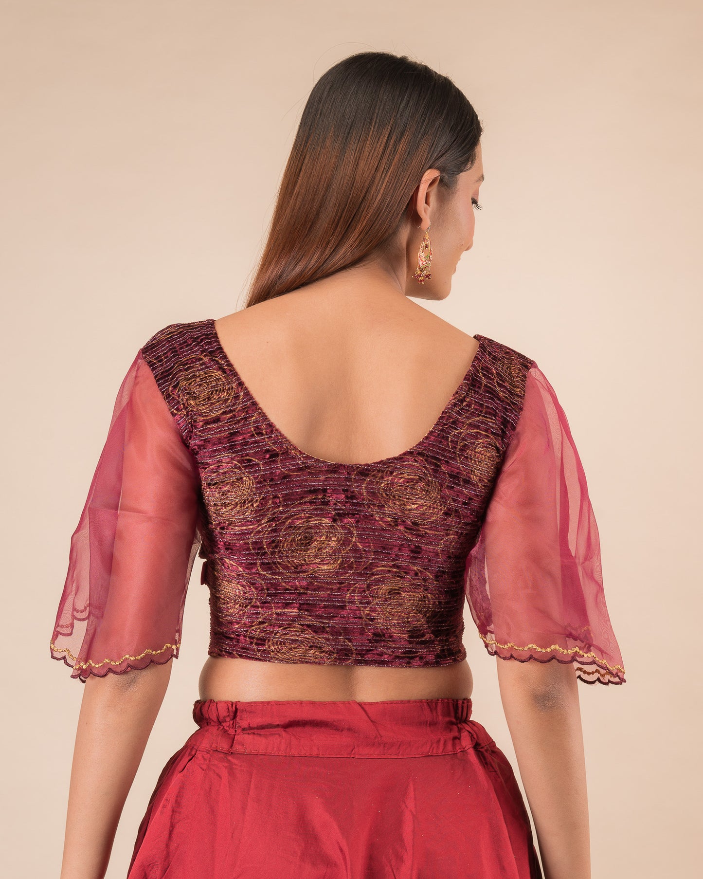 Rear view showcasing the layered bell sleeve detail.