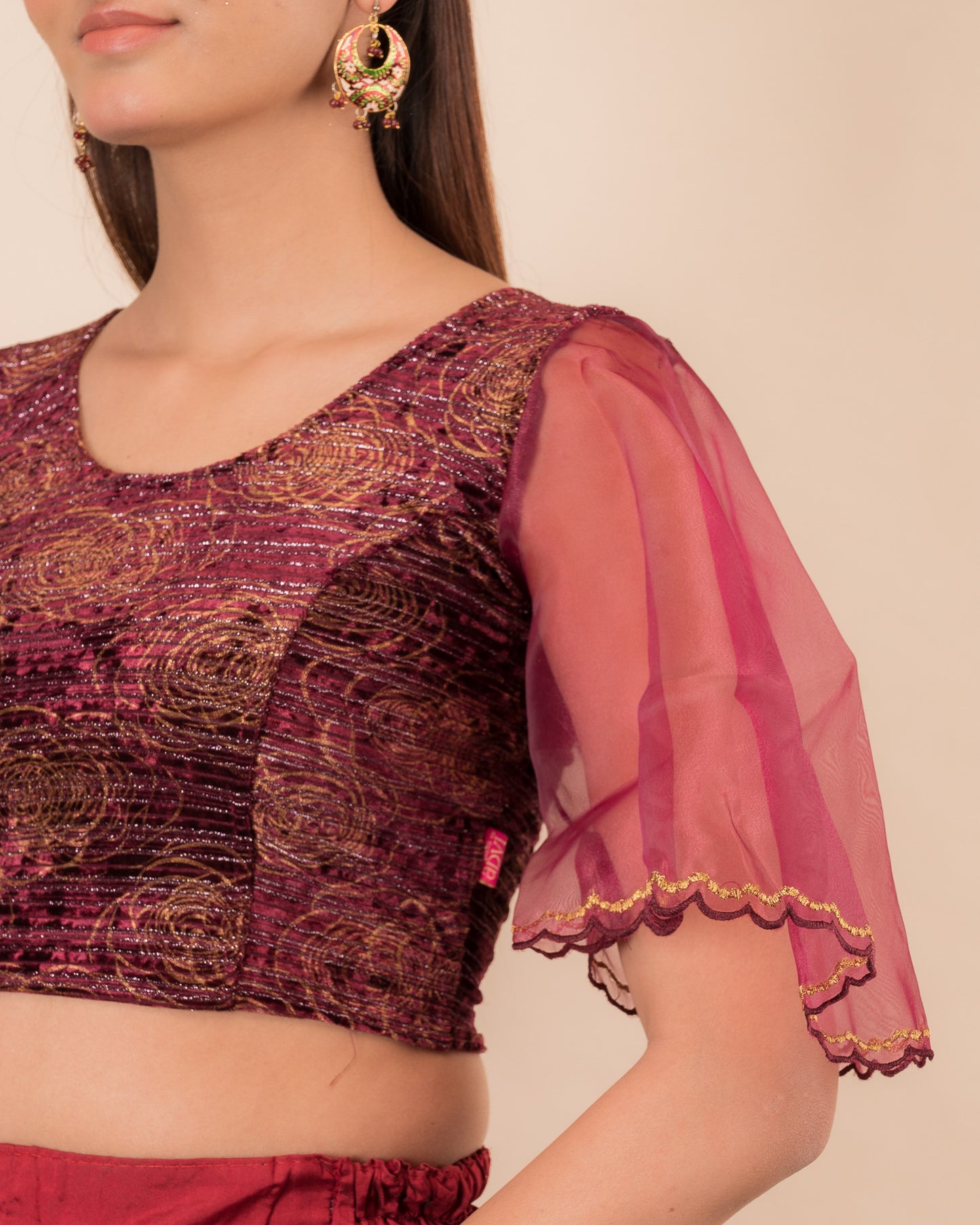 Close-up of velvet fabric and embroidered organza sleeve.