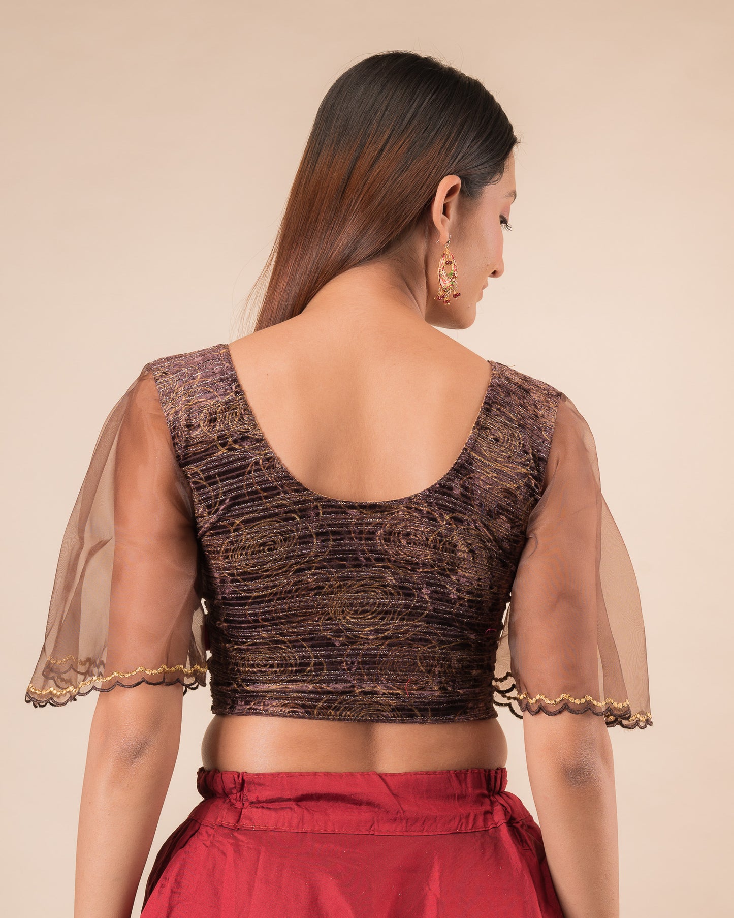 Rear view showcasing the layered bell sleeve detail.