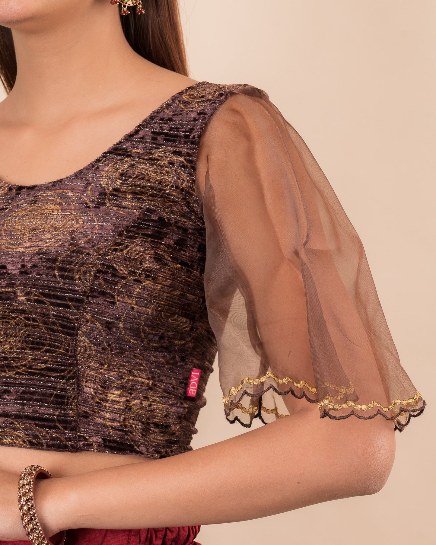 Close-up of velvet fabric and embroidered organza sleeve.