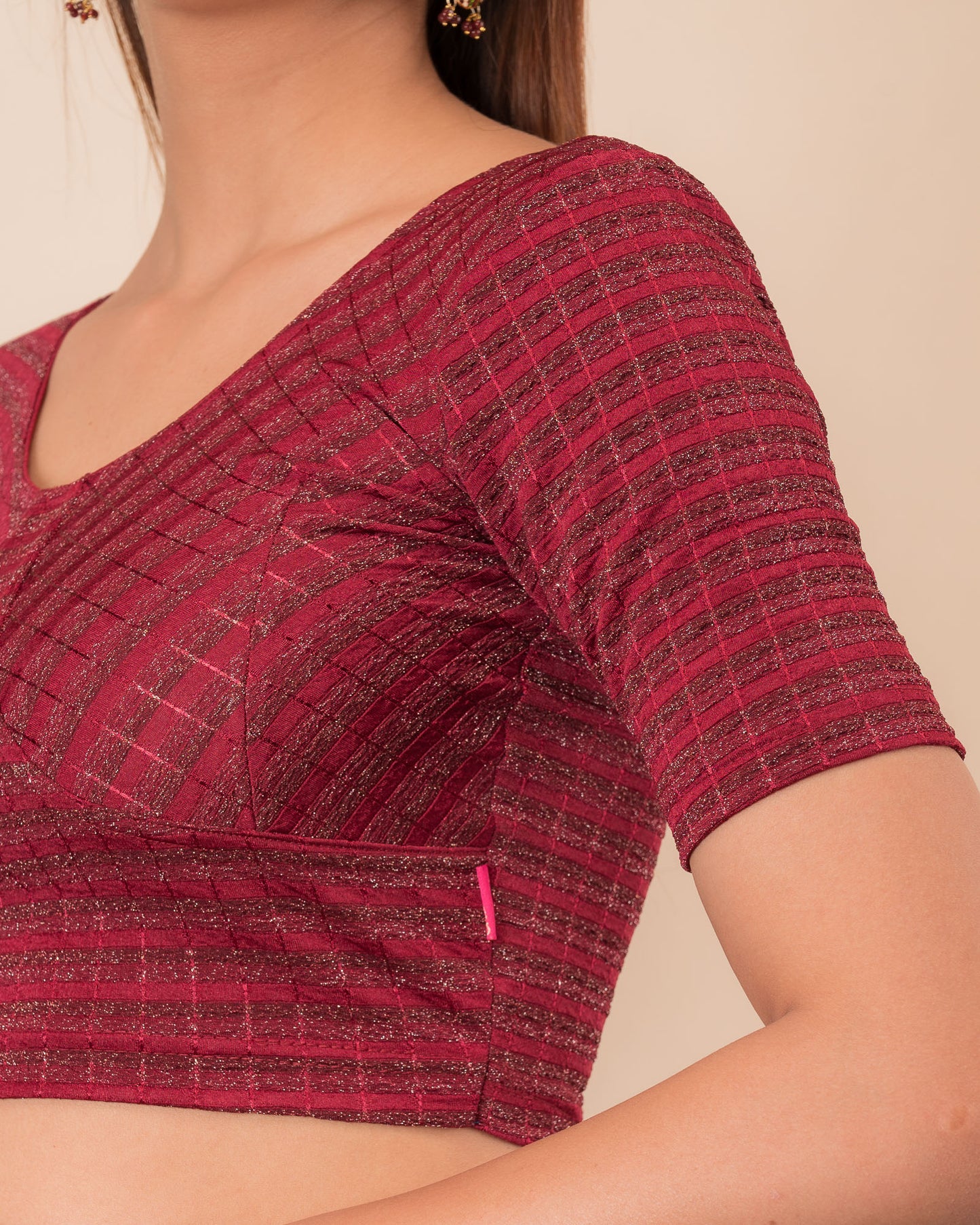 Close-up of the zari stripe fabric detailing the texture and stretchability of the readymade blouse