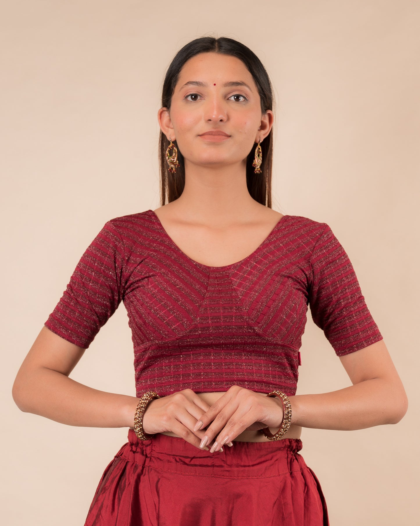 Model wearing a zari stripe stretchable readymade blouse with elbow sleeves and round neckline