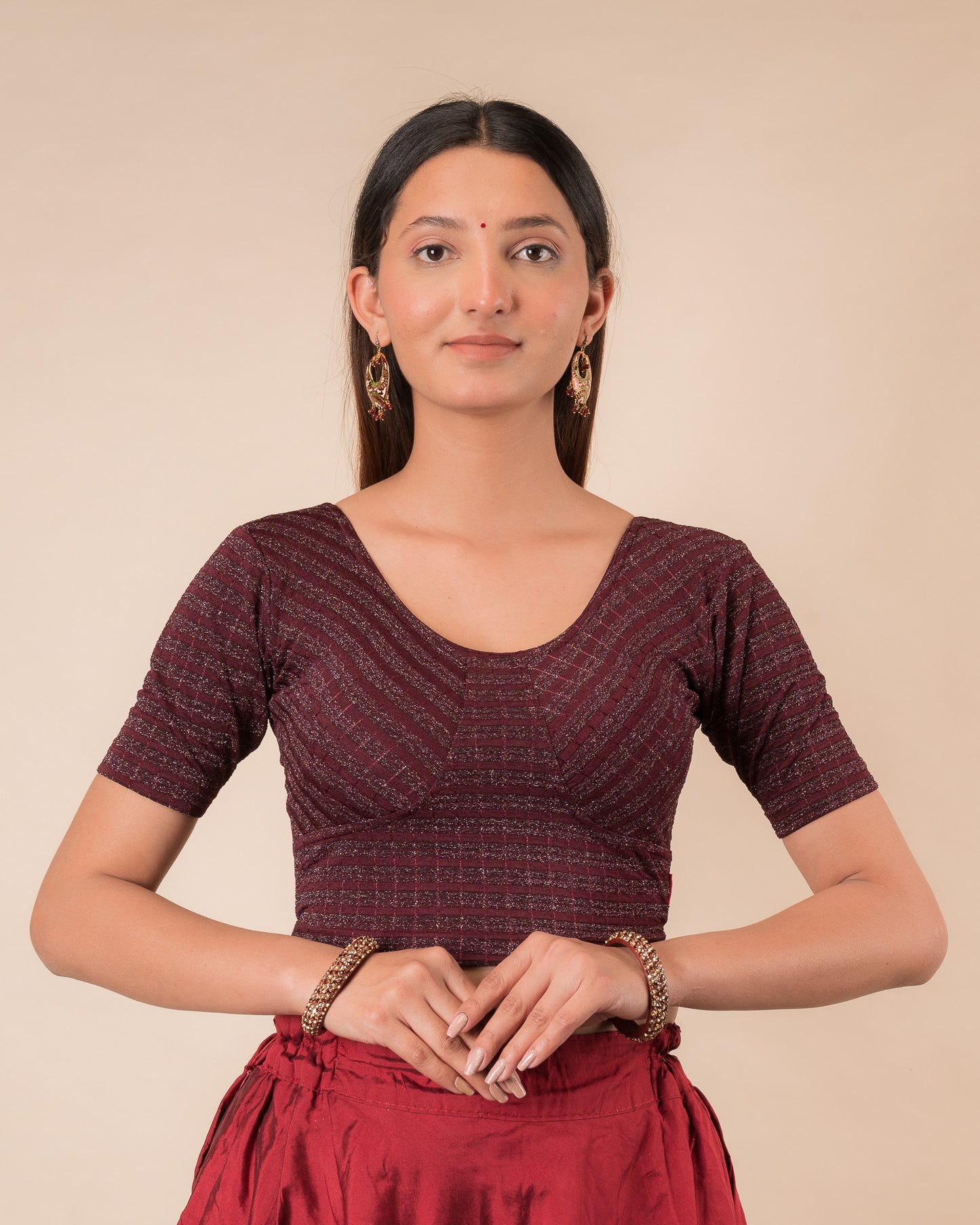 Model wearing a zari stripe stretchable readymade blouse with elbow sleeves and round neckline