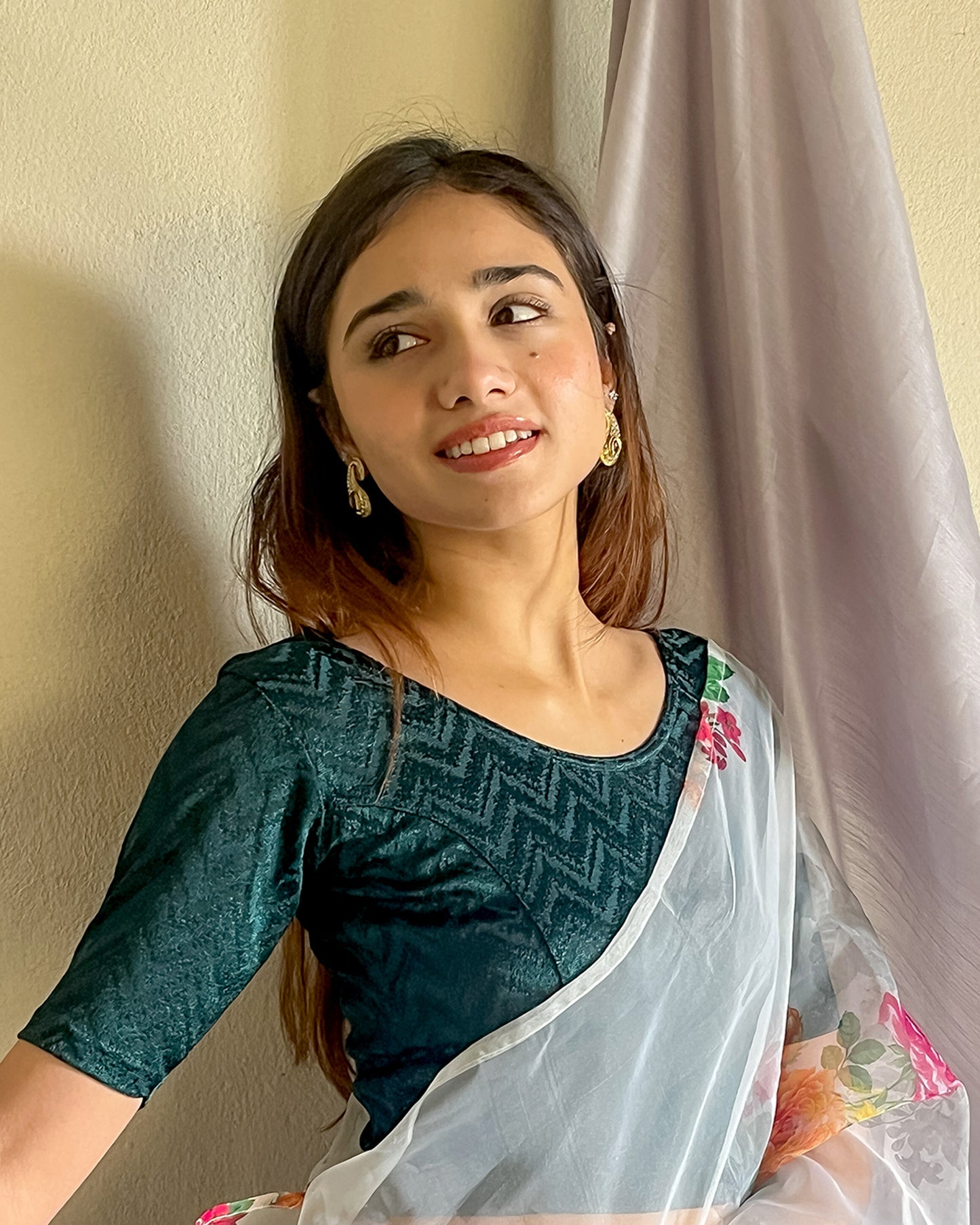 Model pairing the maroon melange zig-zag blouse with a traditional saree, demonstrating a complete ethnic look