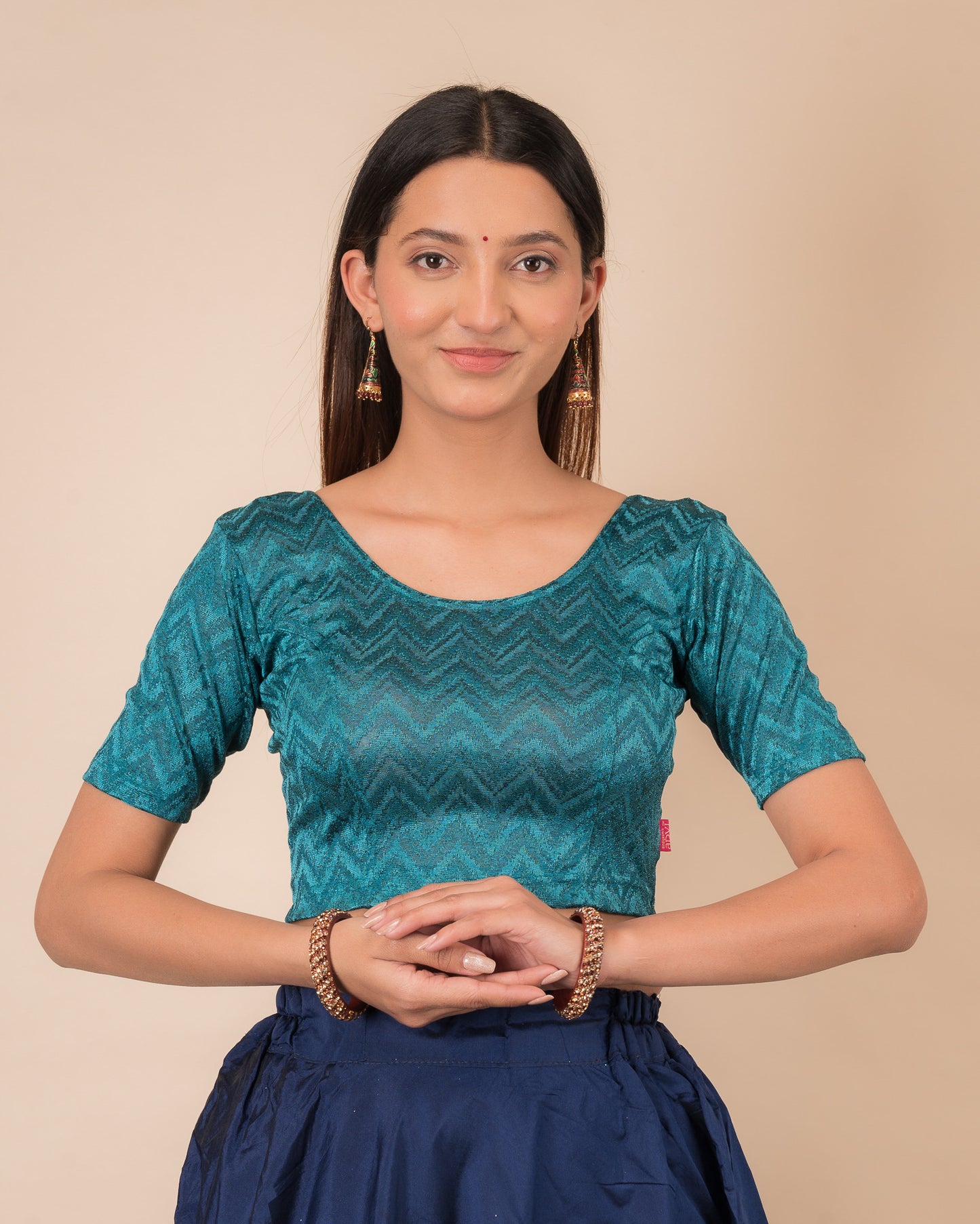 Model wearing a maroon melange zig-zag patterned stretchable readymade blouse with elbow sleeves and round neckline