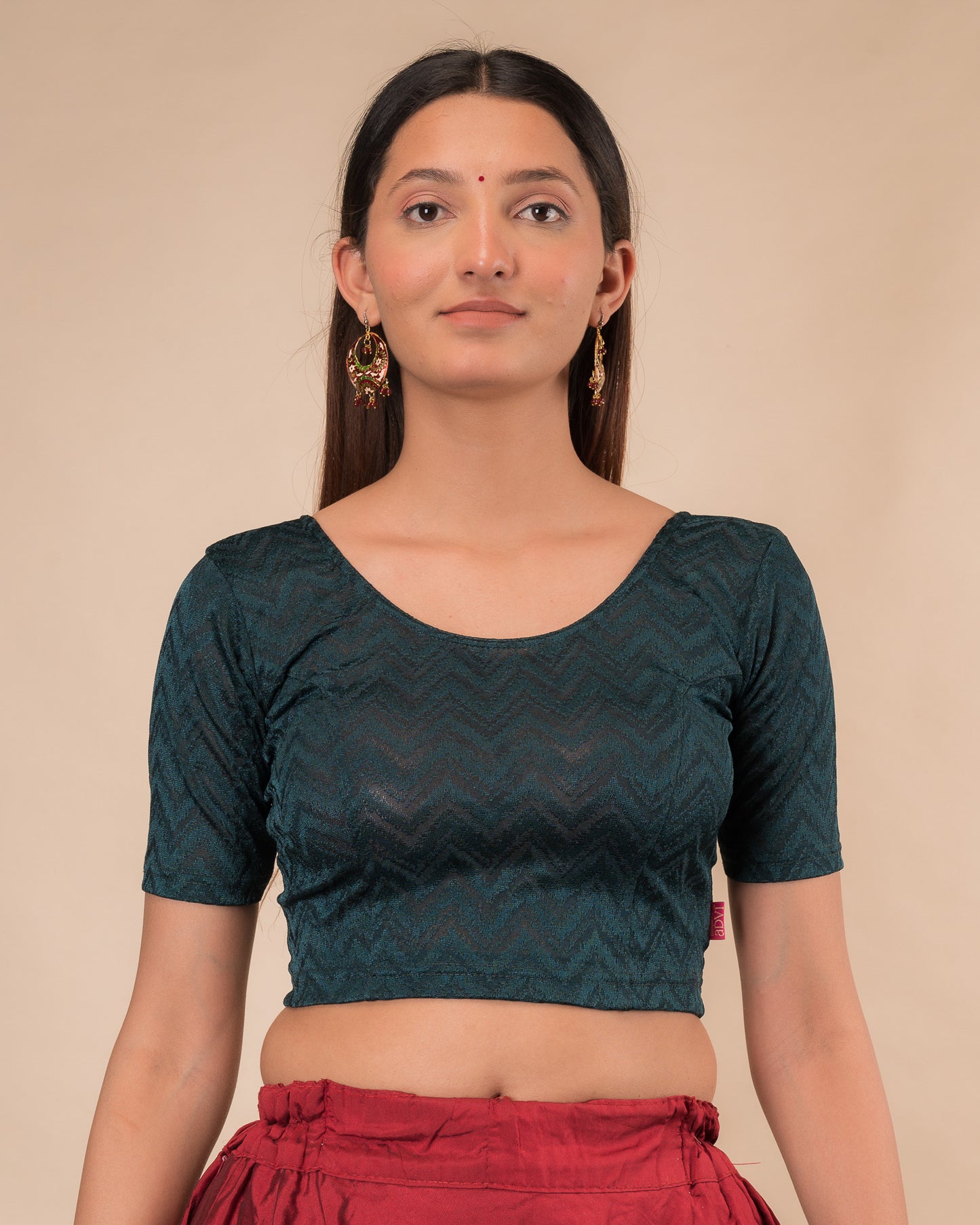 Model wearing a maroon melange zig-zag patterned stretchable readymade blouse with elbow sleeves and round neckline