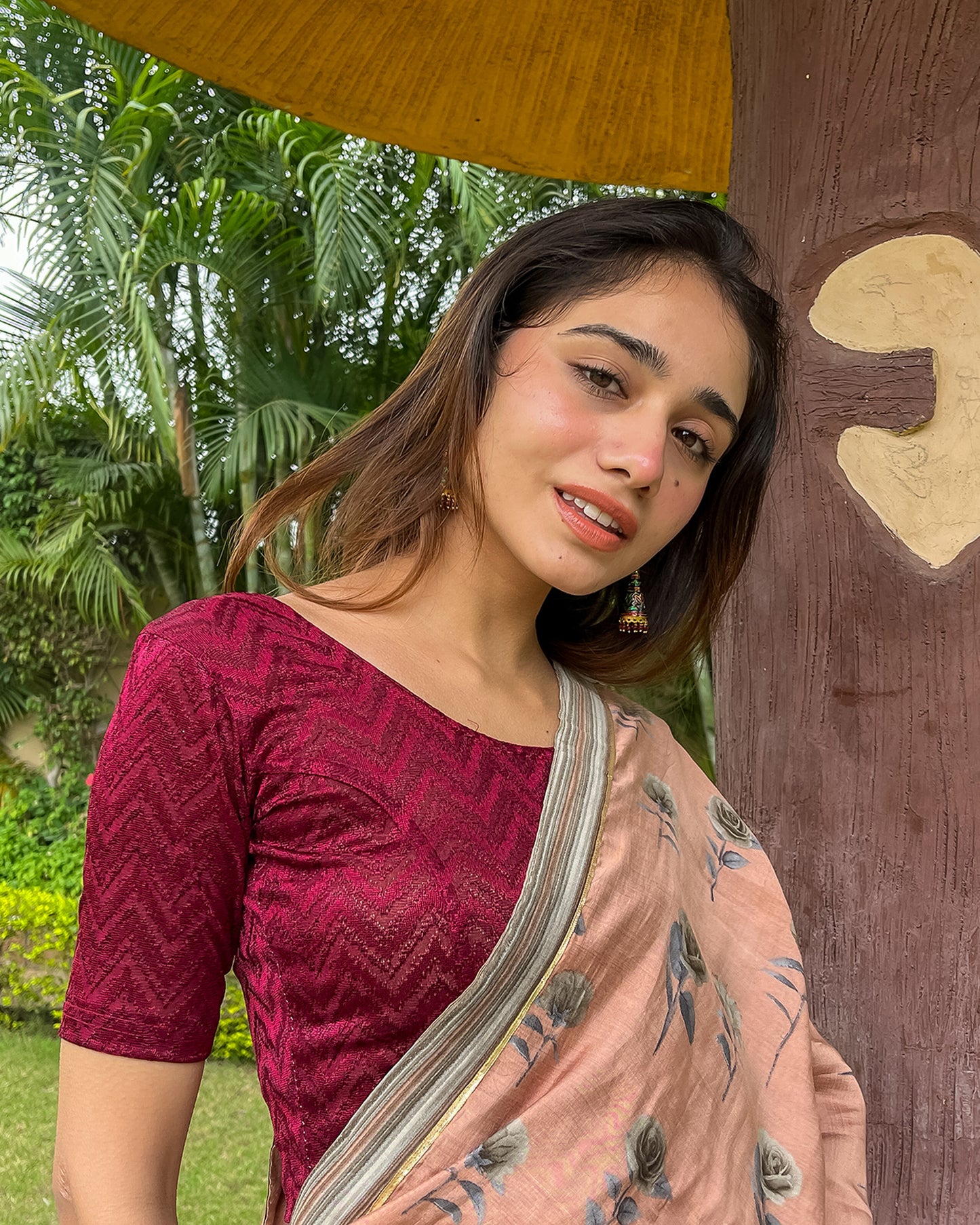 Model pairing the maroon melange zig-zag blouse with a traditional saree, demonstrating a complete ethnic look