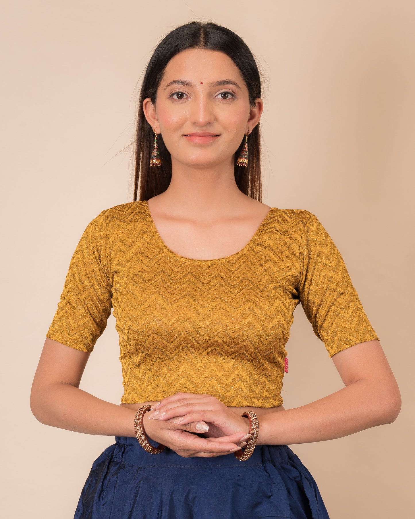 Model wearing a maroon melange zig-zag patterned stretchable readymade blouse with elbow sleeves and round neckline
