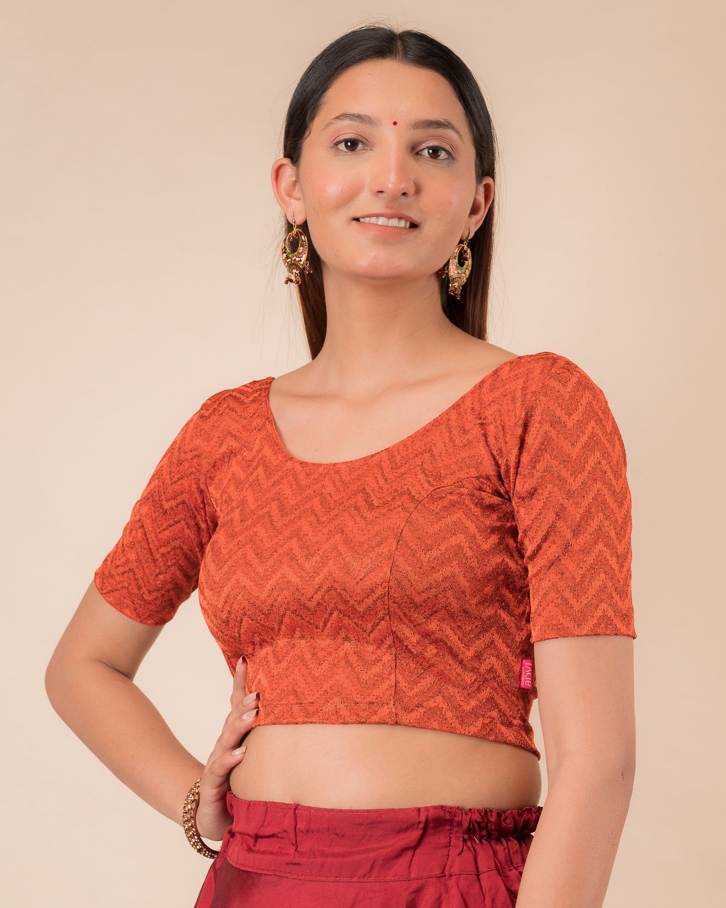 Side profile of the maroon melange zig-zag blouse highlighting the fit and sleeve length