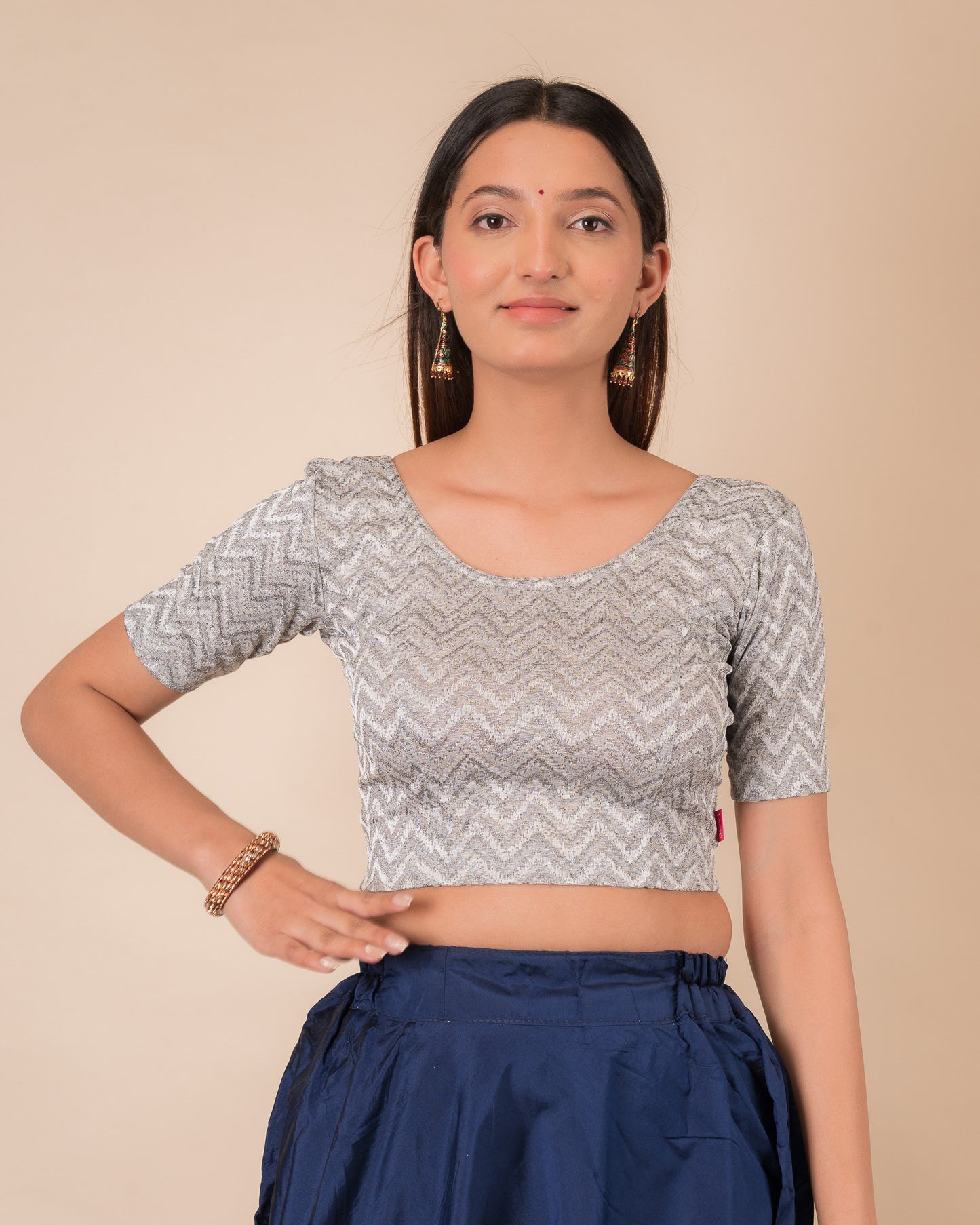 Model wearing a maroon melange zig-zag patterned stretchable readymade blouse with elbow sleeves and round neckline