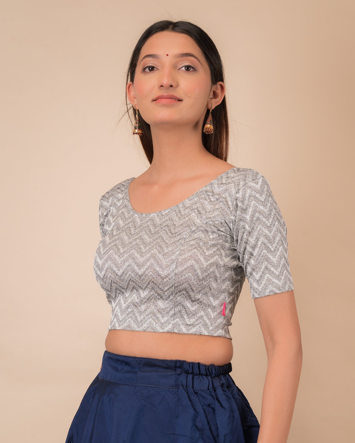 Side profile of the maroon melange zig-zag blouse highlighting the fit and sleeve length