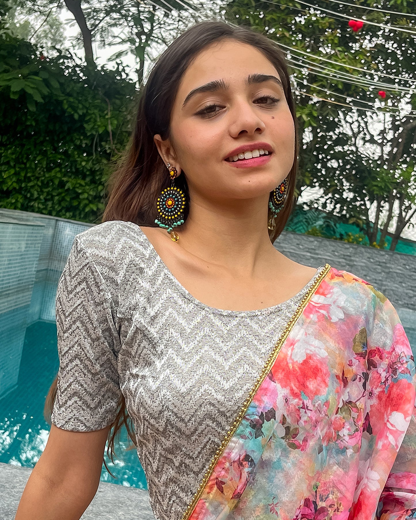 Model pairing the maroon melange zig-zag blouse with a traditional saree, demonstrating a complete ethnic look