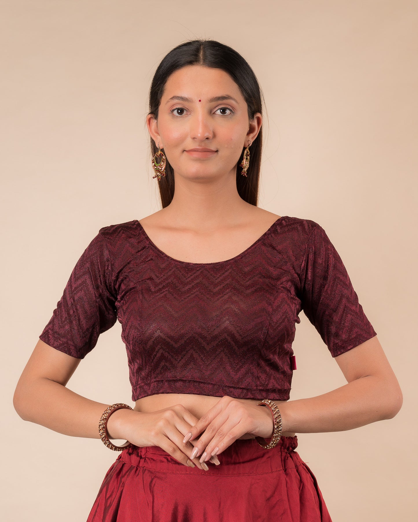 Model wearing a maroon melange zig-zag patterned stretchable readymade blouse with elbow sleeves and round neckline