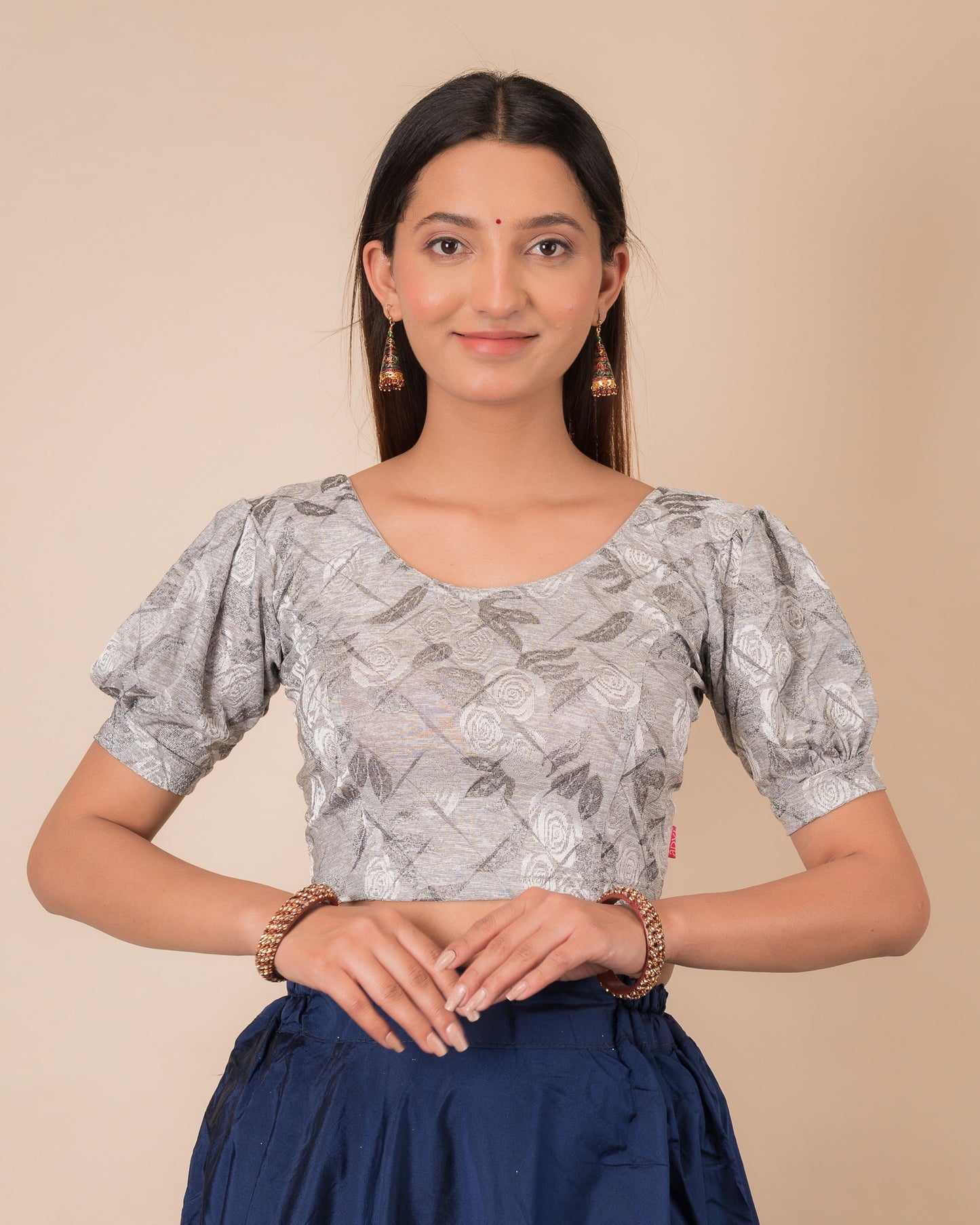 Model wearing a grey melange stretchable readymade blouse with puffed elbow sleeves and round neckline