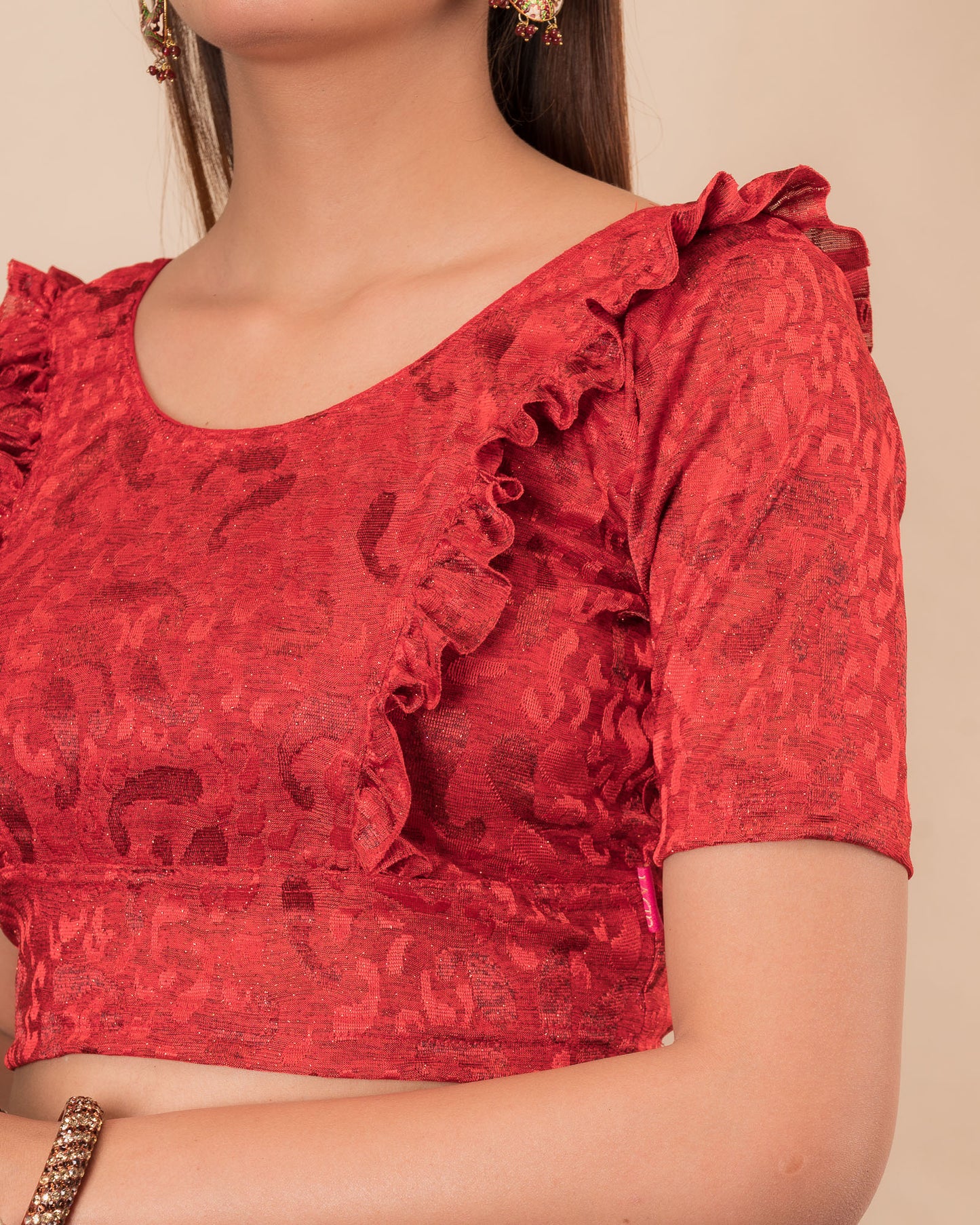 Close-up of the melange jacquard knit with subtle glitter and paisley pattern