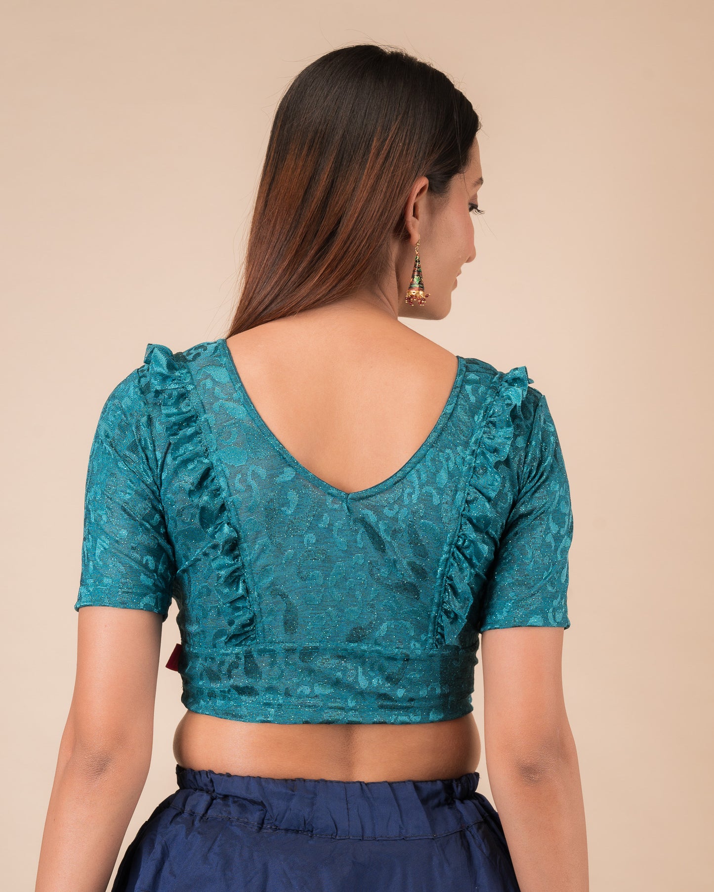 Rear view showcasing the slip-on design and ruffled shoulder detail