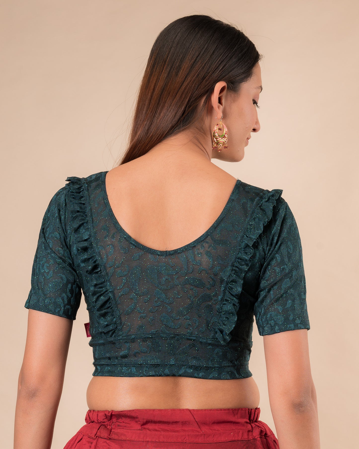 Rear view showcasing the slip-on design and ruffled shoulder detail