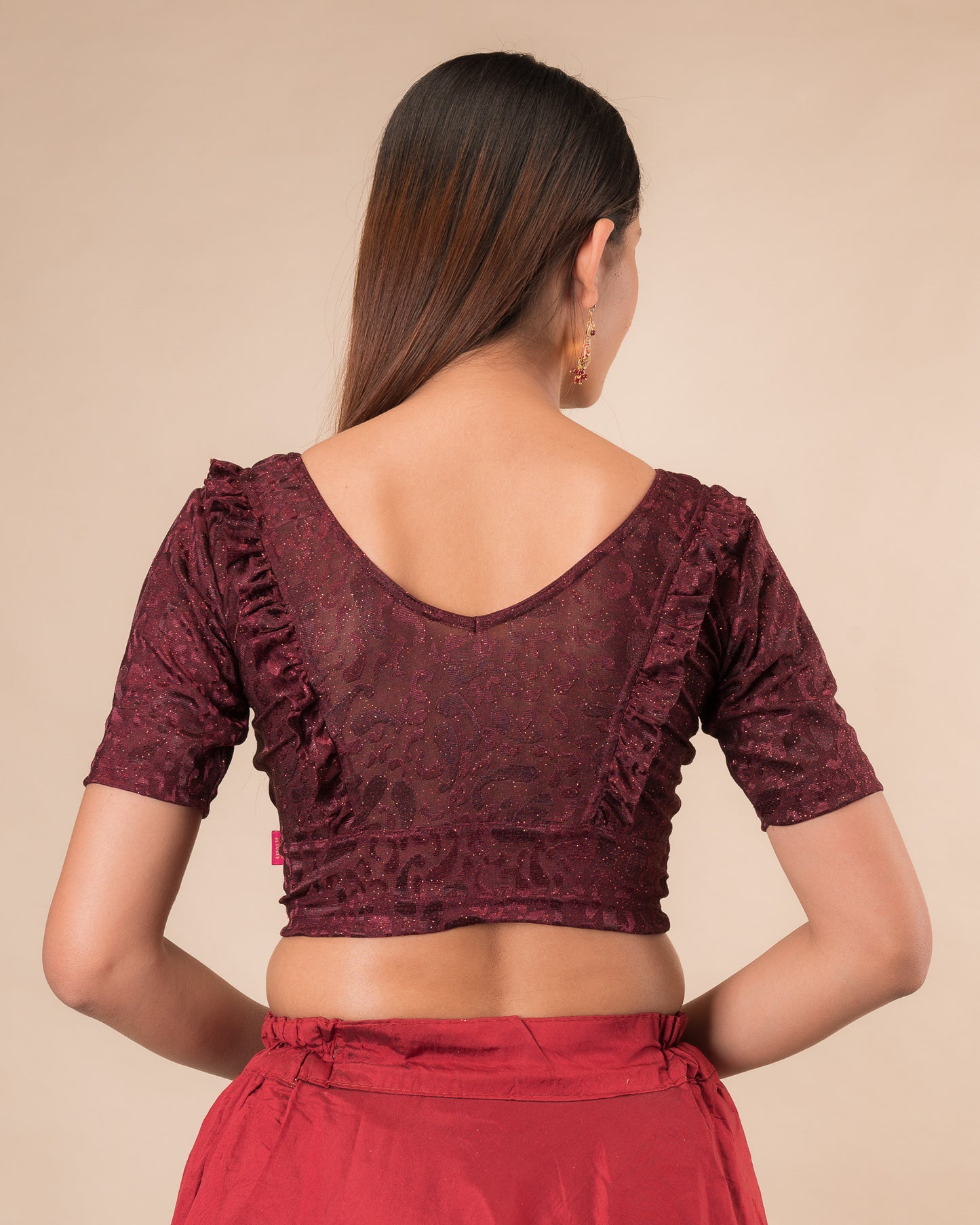Rear view showcasing the slip-on design and ruffled shoulder detail