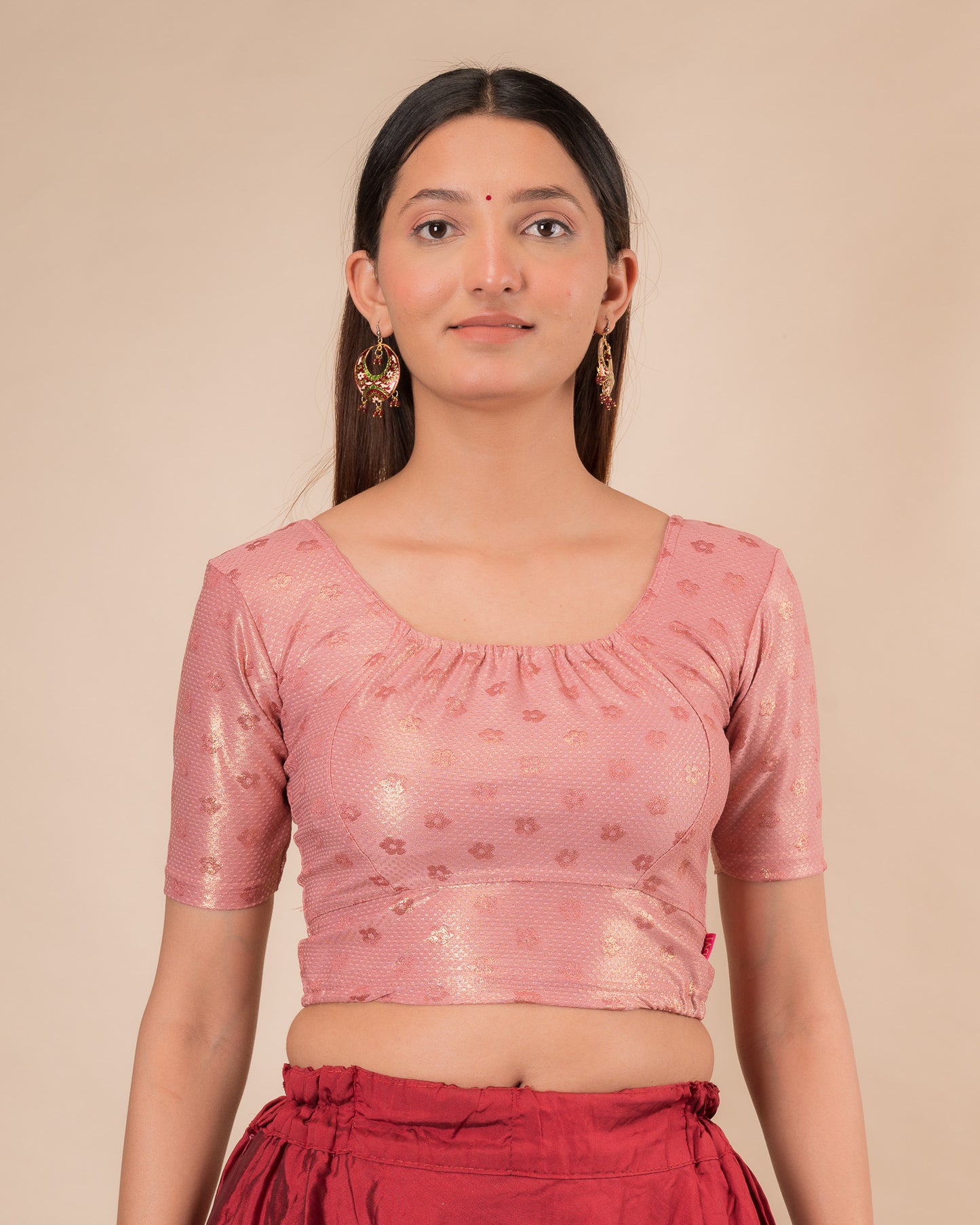 Model wearing a metallic zig-zag striped stretchable choli-style blouse with elbow sleeves and round neckline
