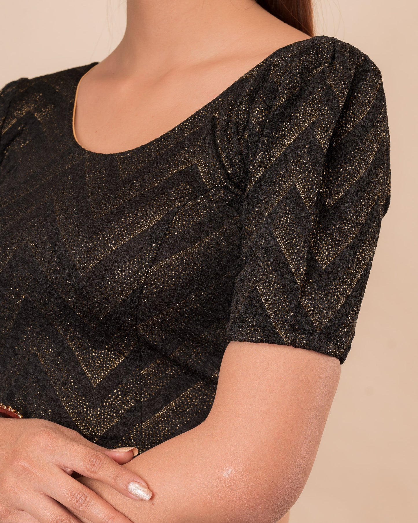 Close-up of the melange jacquard knit with subtle glitter and paisley pattern