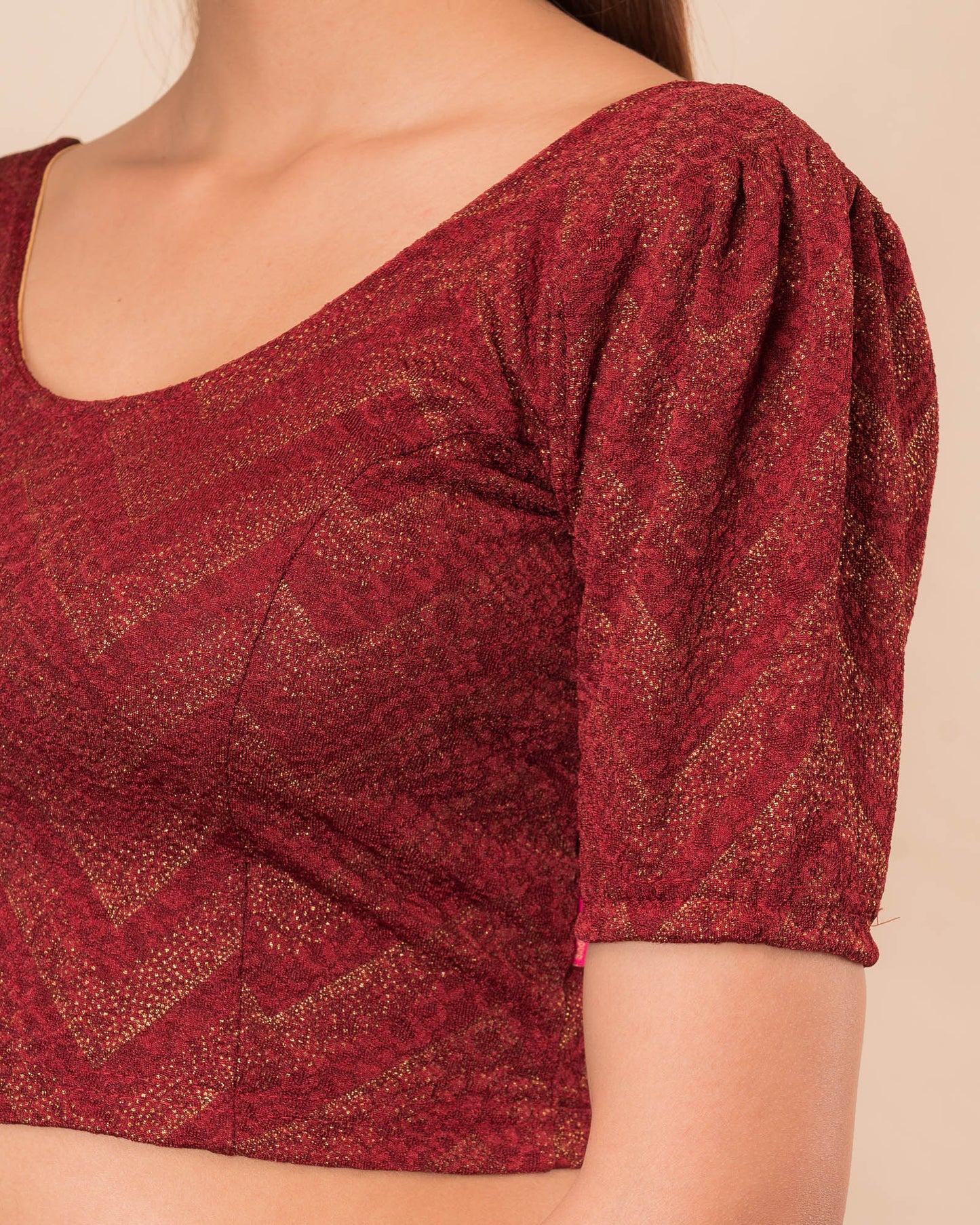 Close-up of the melange jacquard knit with subtle glitter and paisley pattern
